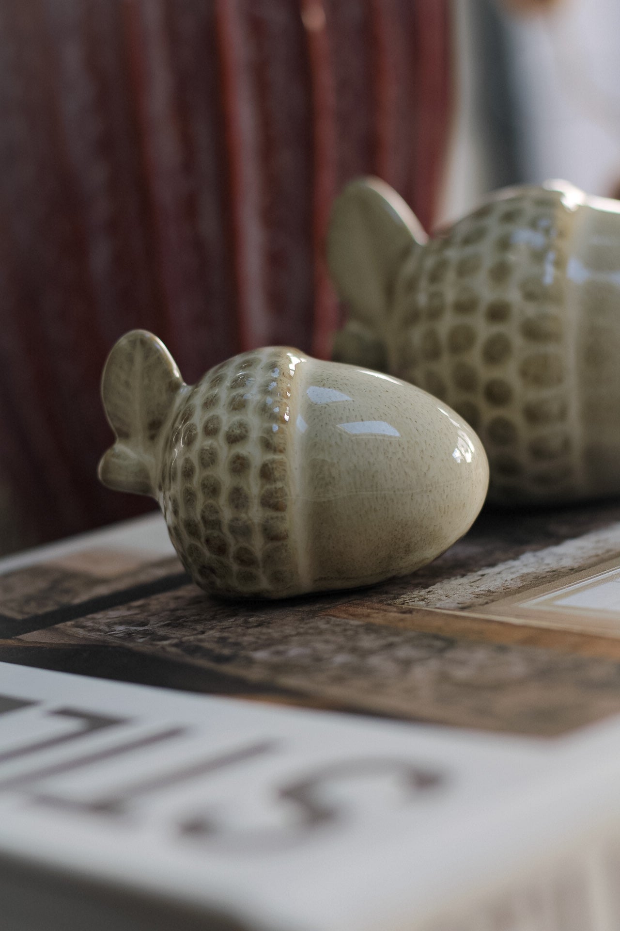close up of small glazed ceramic acorn