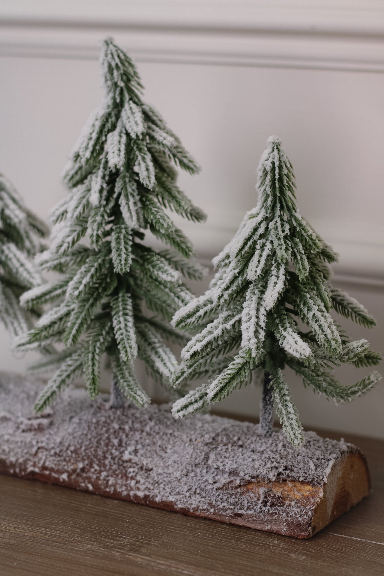Snowy Faux Christmas Trees on a Rustic Log