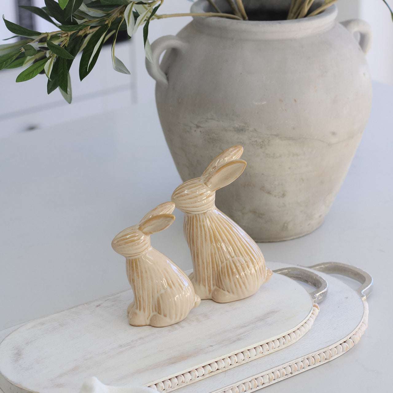 Neutral Sitting Ribbed Bunny on top of wooden styling board