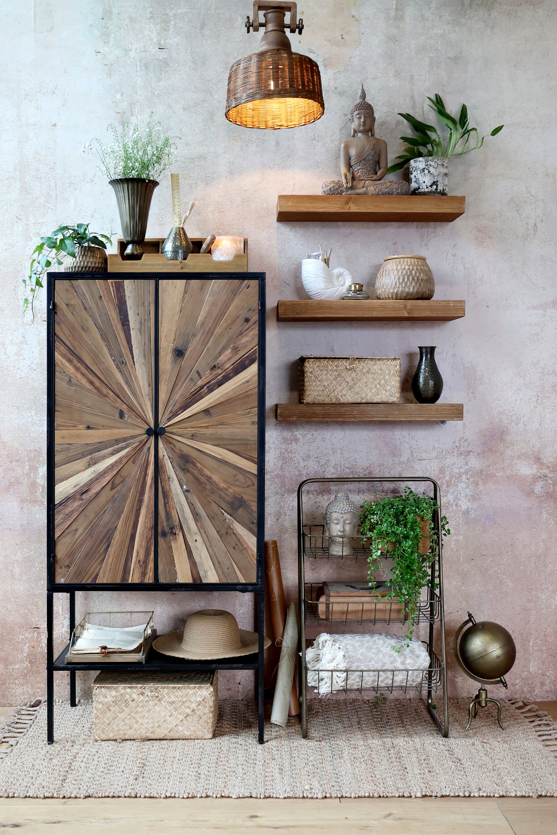 Decorative interior with wooden shelves, a cabinet with a sunburst design, and various decorative items.
