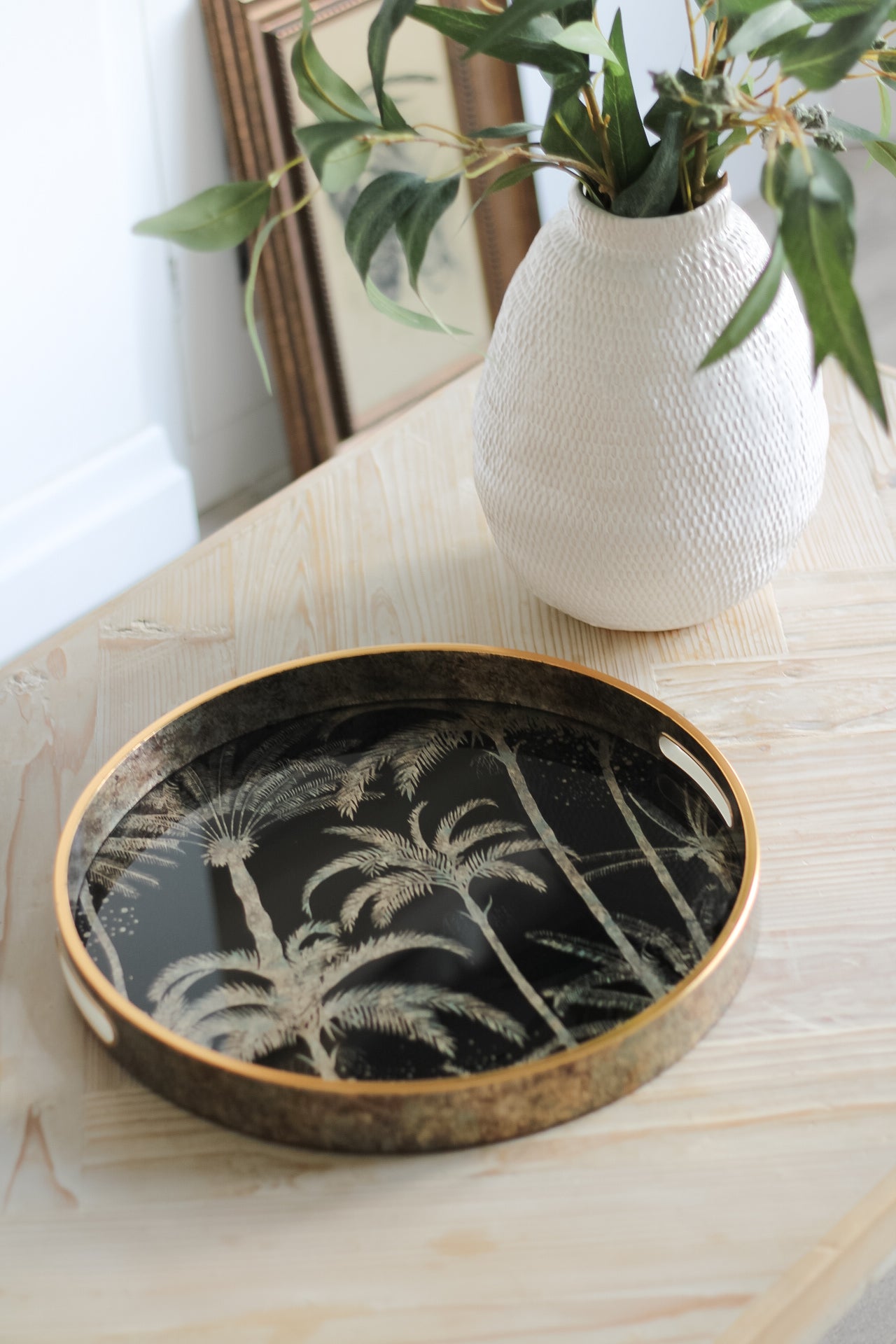 wooden rectangular coffee table styled with gold round tray