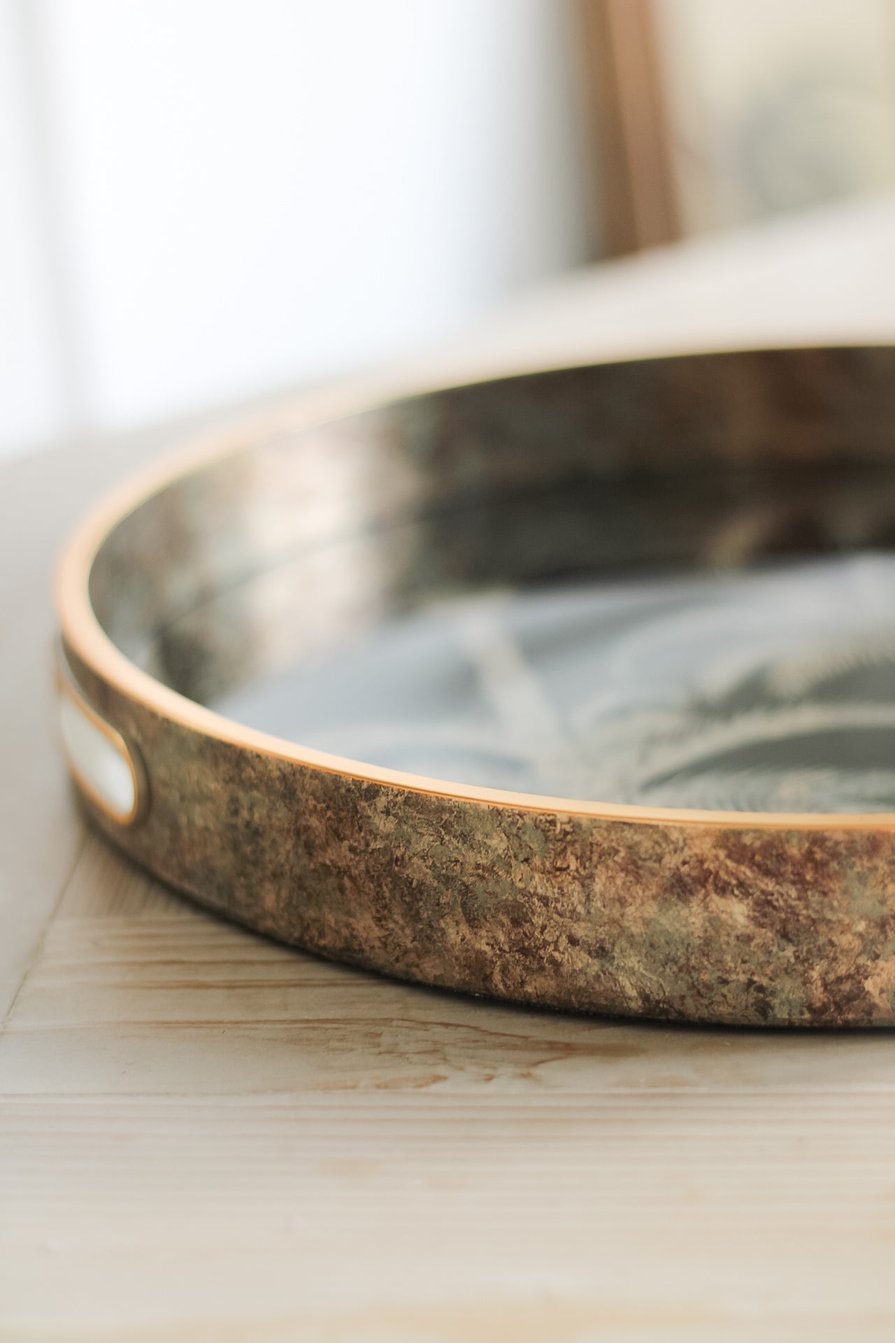 up close of round gold coffee table tray