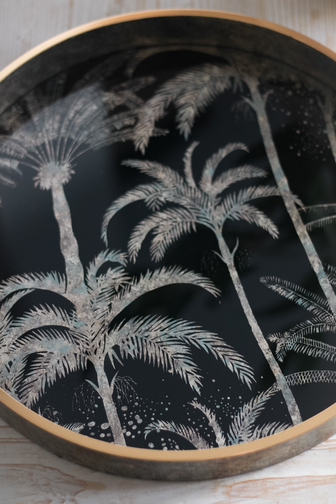 black base of tray with golden palm tree design