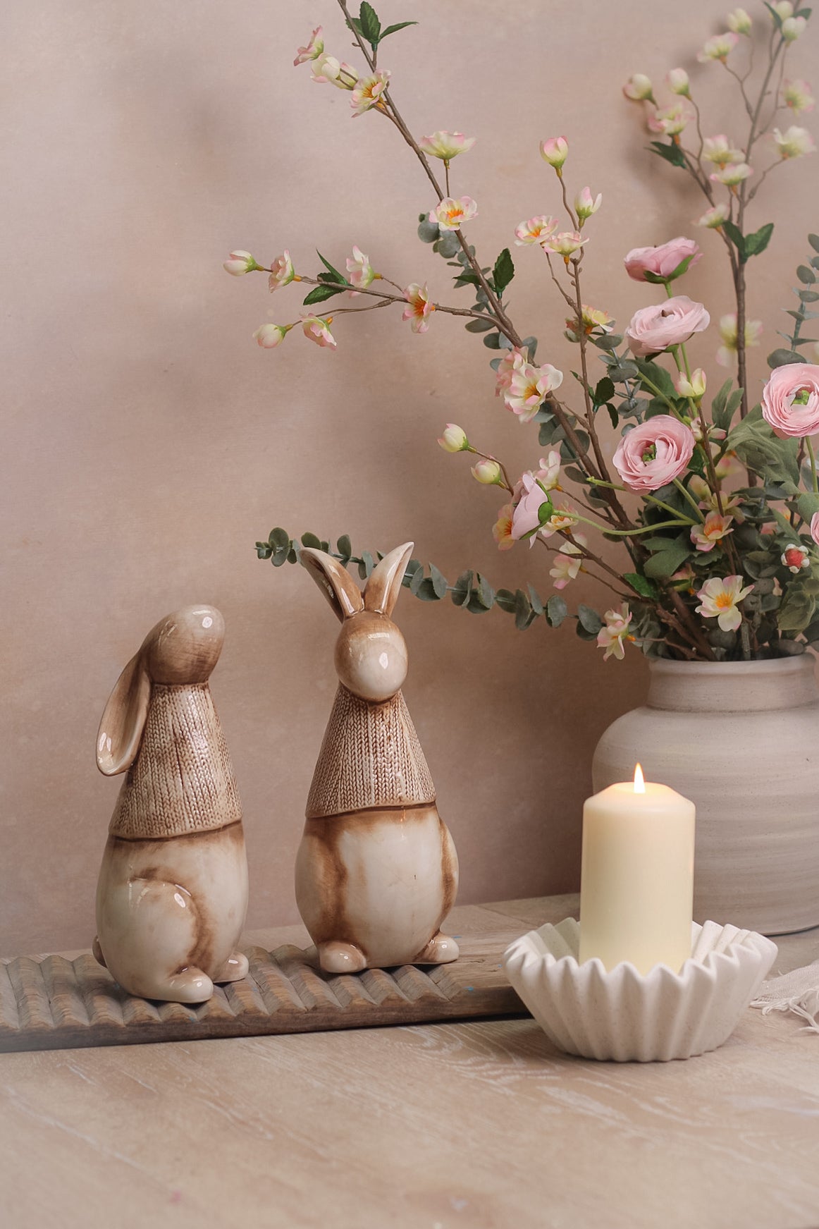 porcelain bunnies with faux flowers in vase
