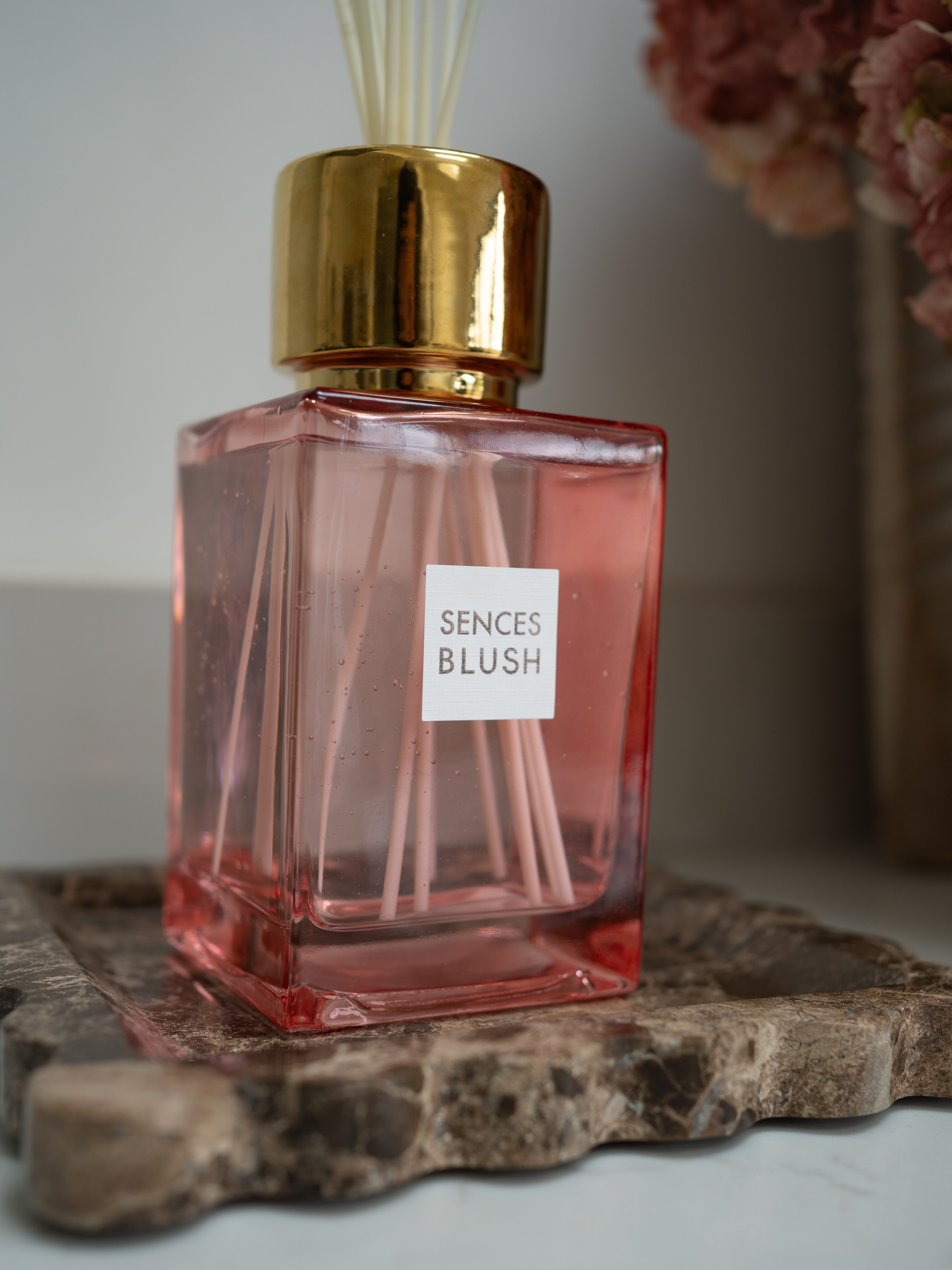 Pink luxury reed diffuser bottle labeled &