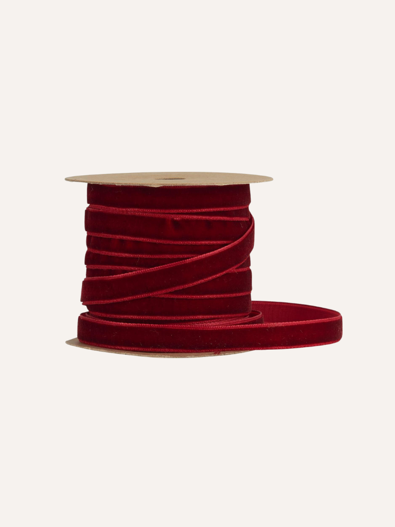 Spool of bordeaux red ribbon on a white background