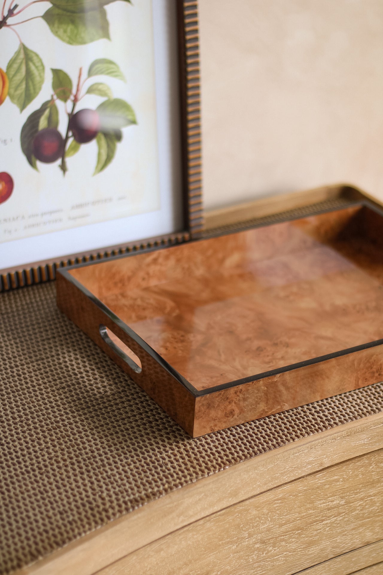 Brown marbled effect tray on a woven mat with a framed picture of fruits in the background