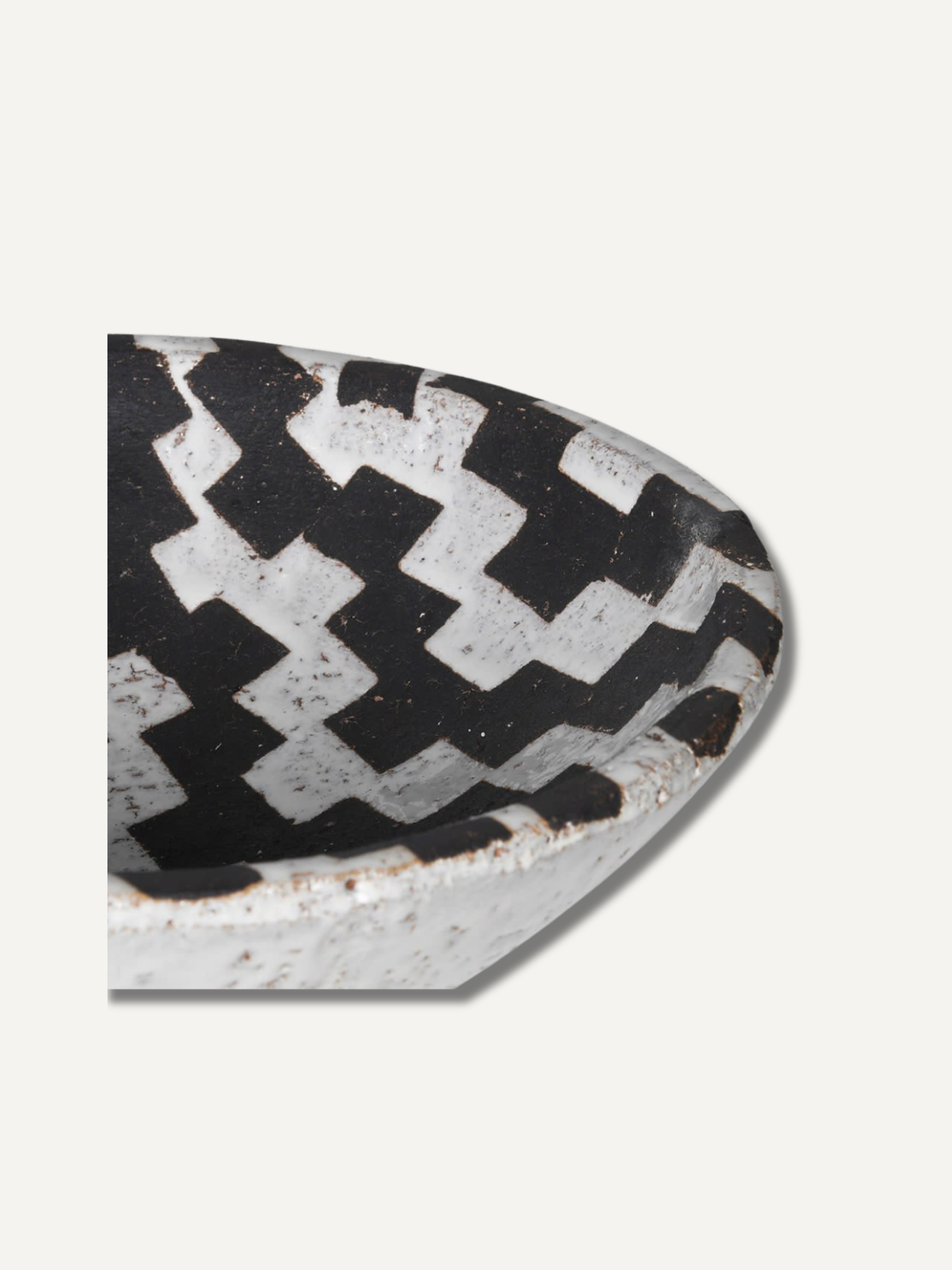 Decorative bowl half-circle with black and white checkered pattern on a light gray background for home decor and styling