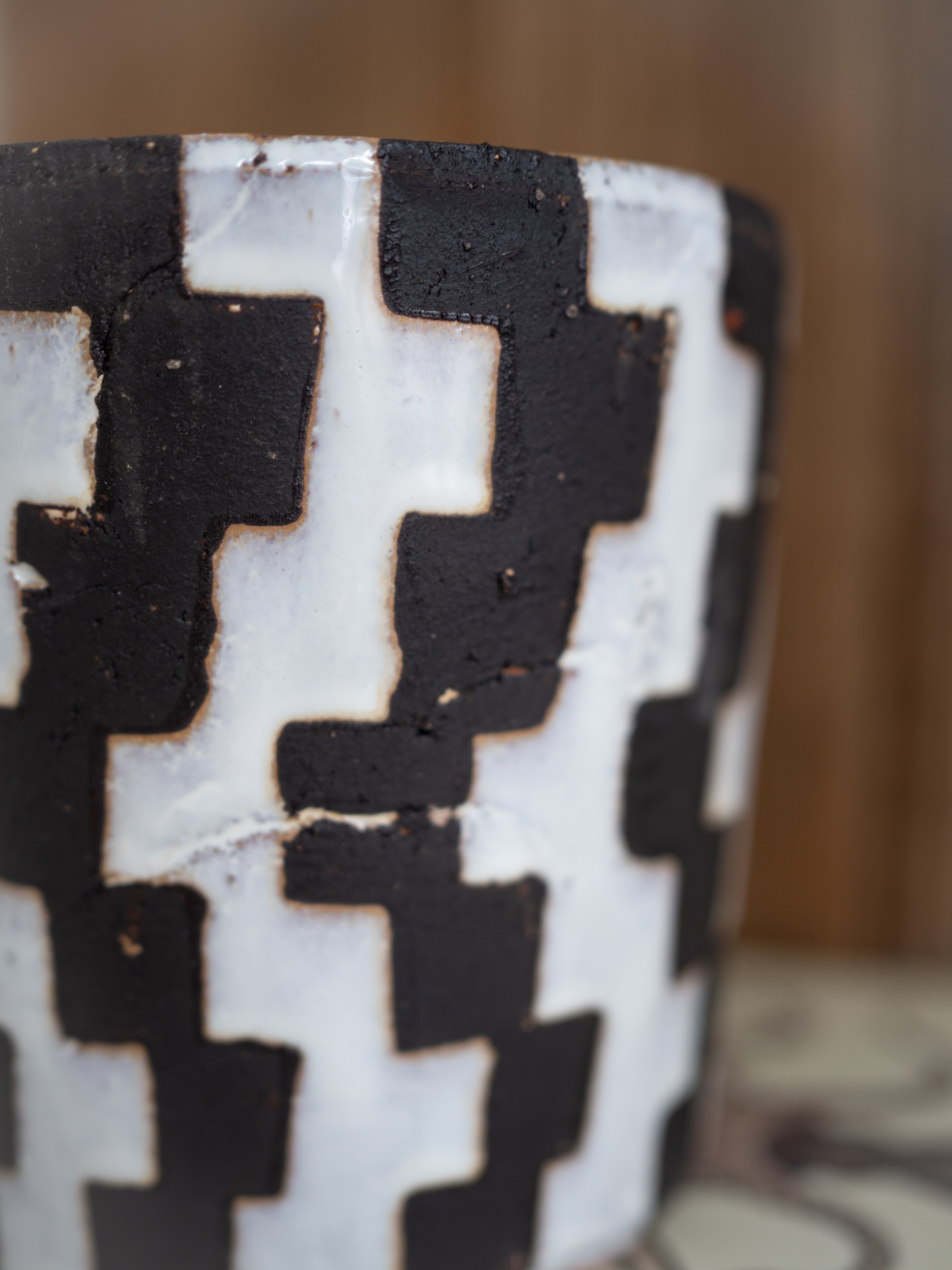 Close-up of a ceramic vase with geometric black and white pattern
