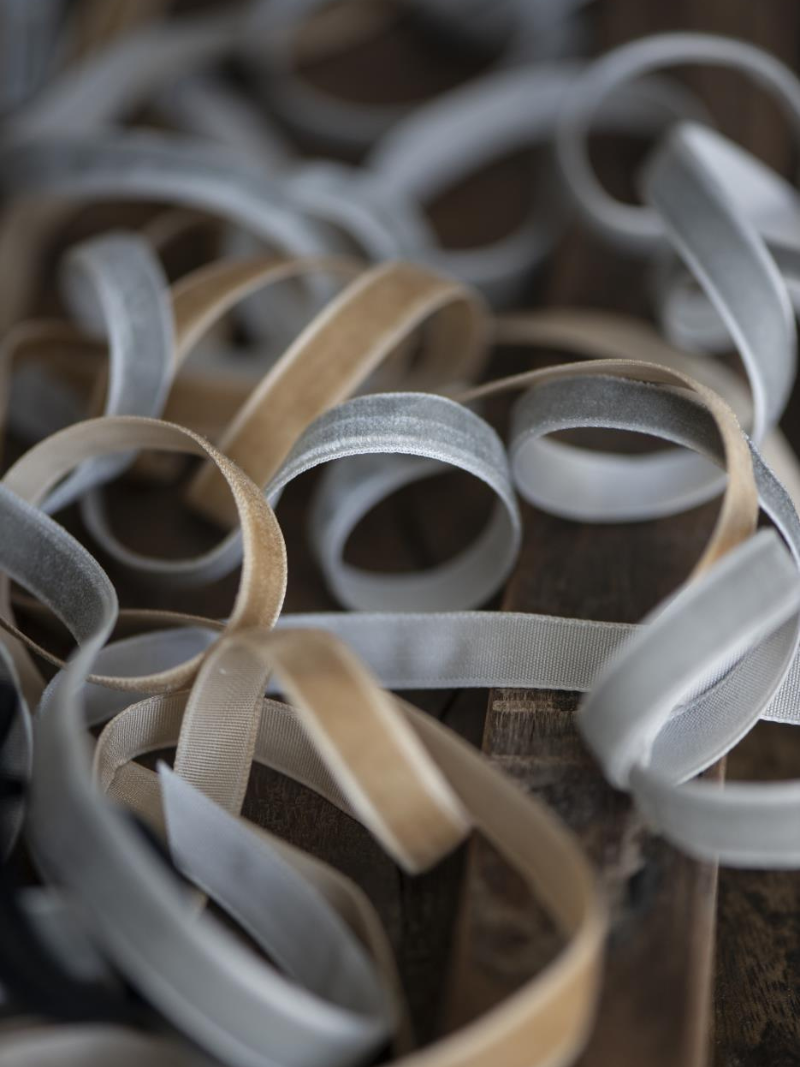 Close-up of beige and white ribbons on a textured surface