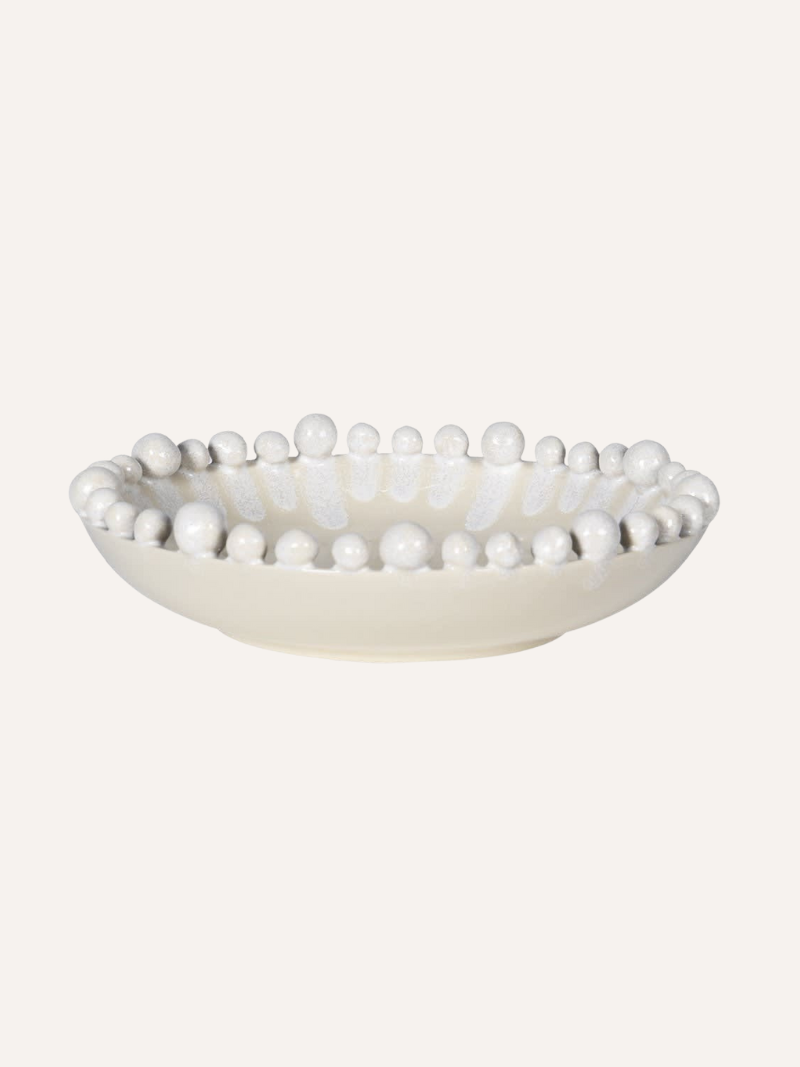 Decorative bowl with bobble embellishments on a white background