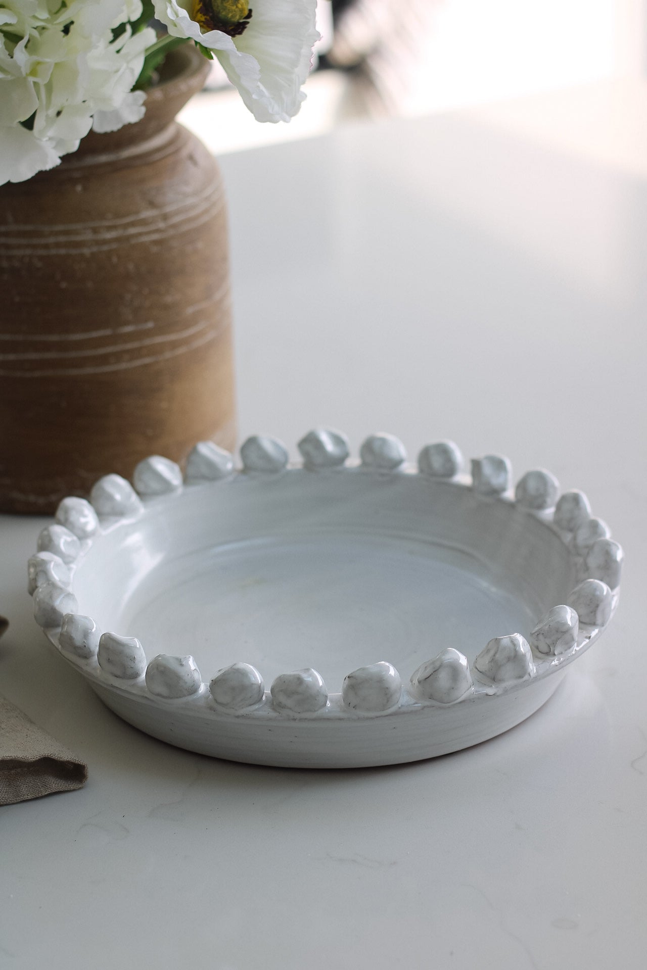Distressed White Bobble Bowl with faux flowers in brown rustic vase