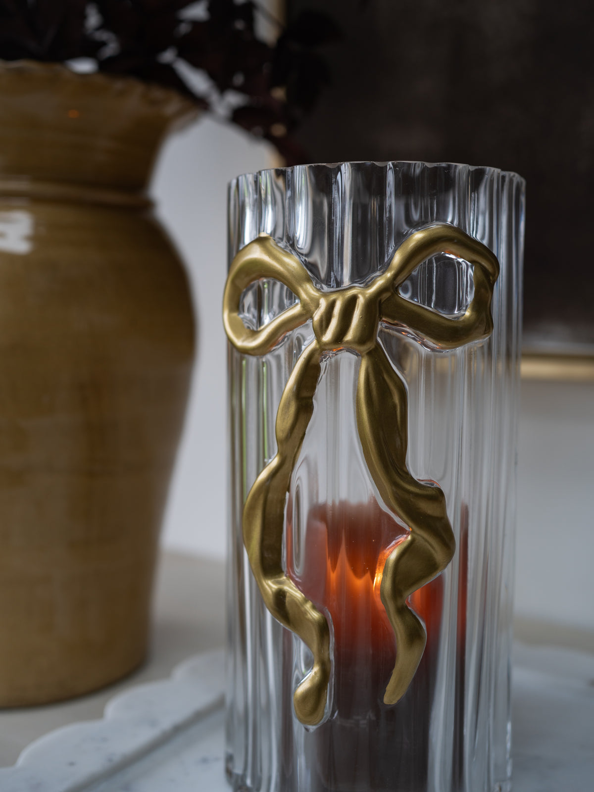 up close of gold bow ribbed candle holder