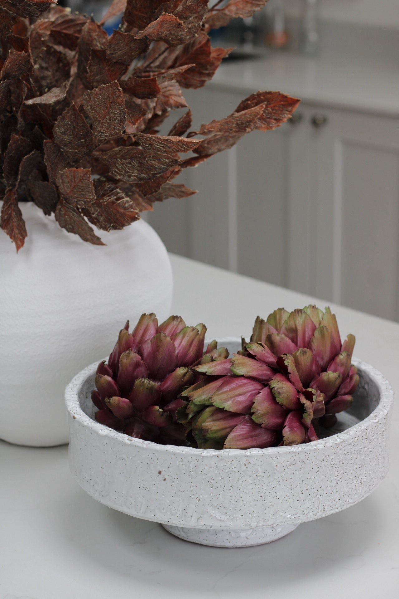 faux artichoke in decorative bowl for home decor