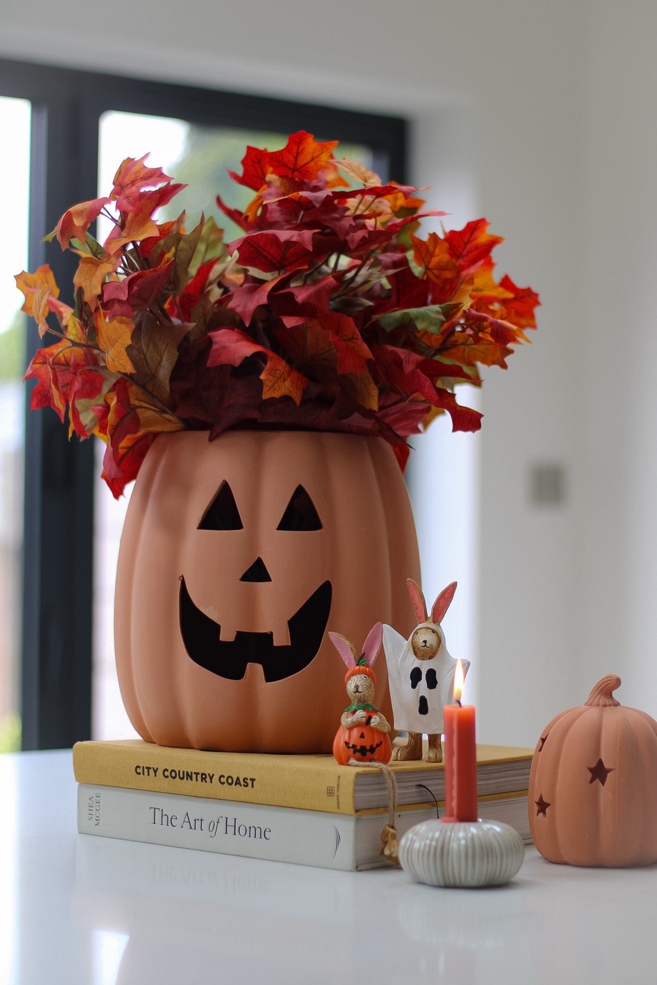 A terracotta pumpkin vase with a jack-o&