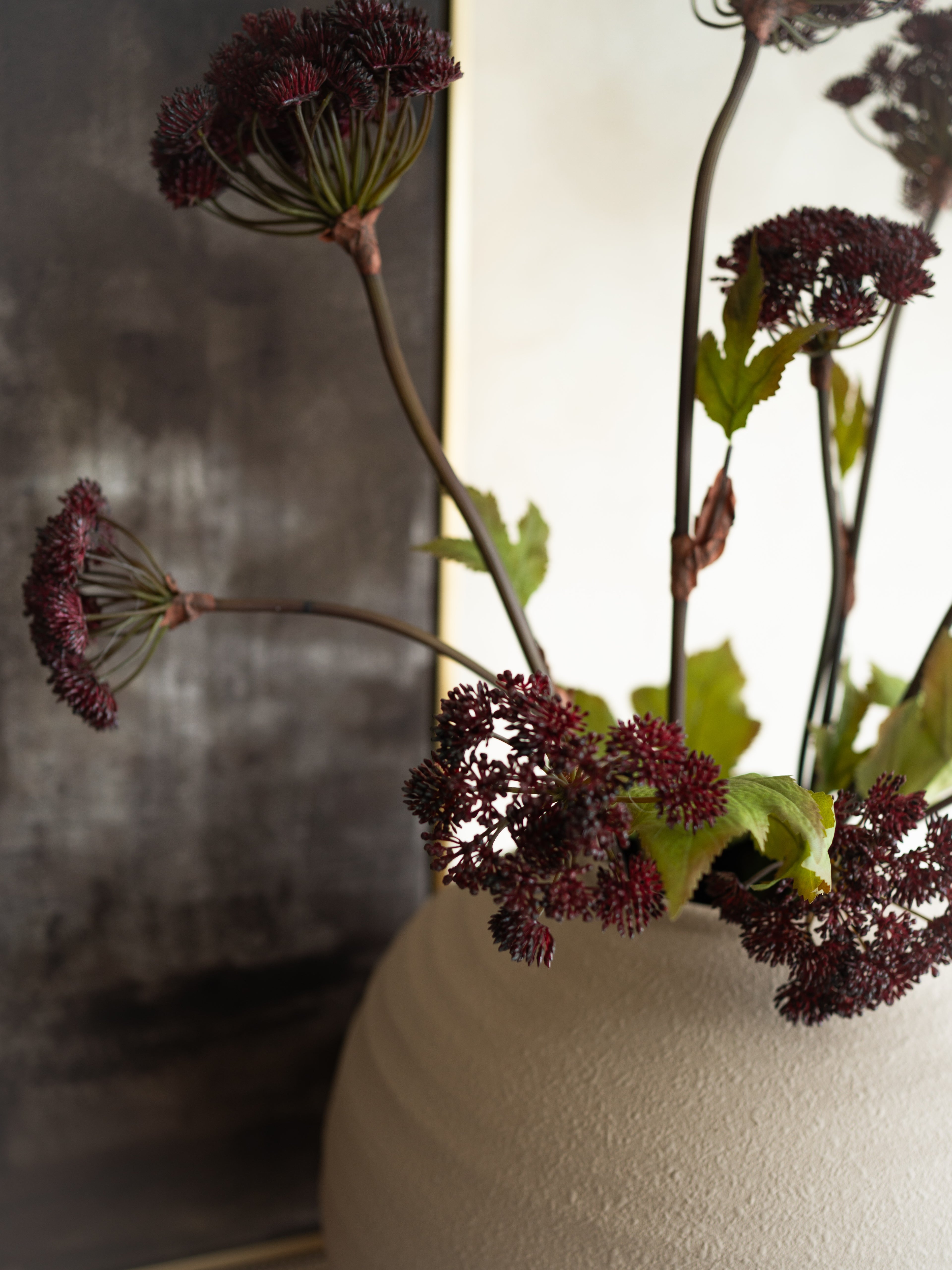 Vase with dried flowers against a blurred background