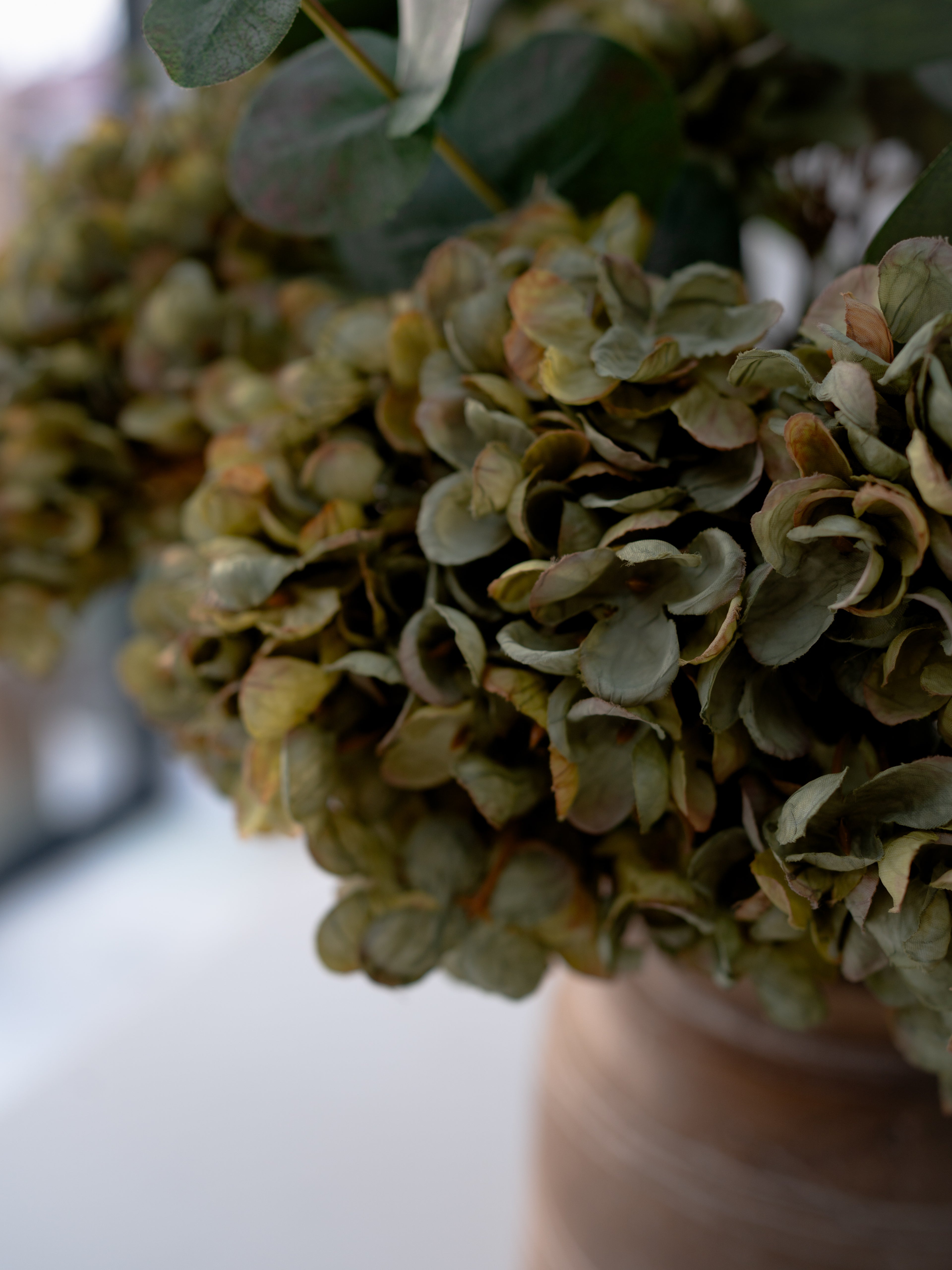 Close-up of faux green hydrangea flowers with a blurred background