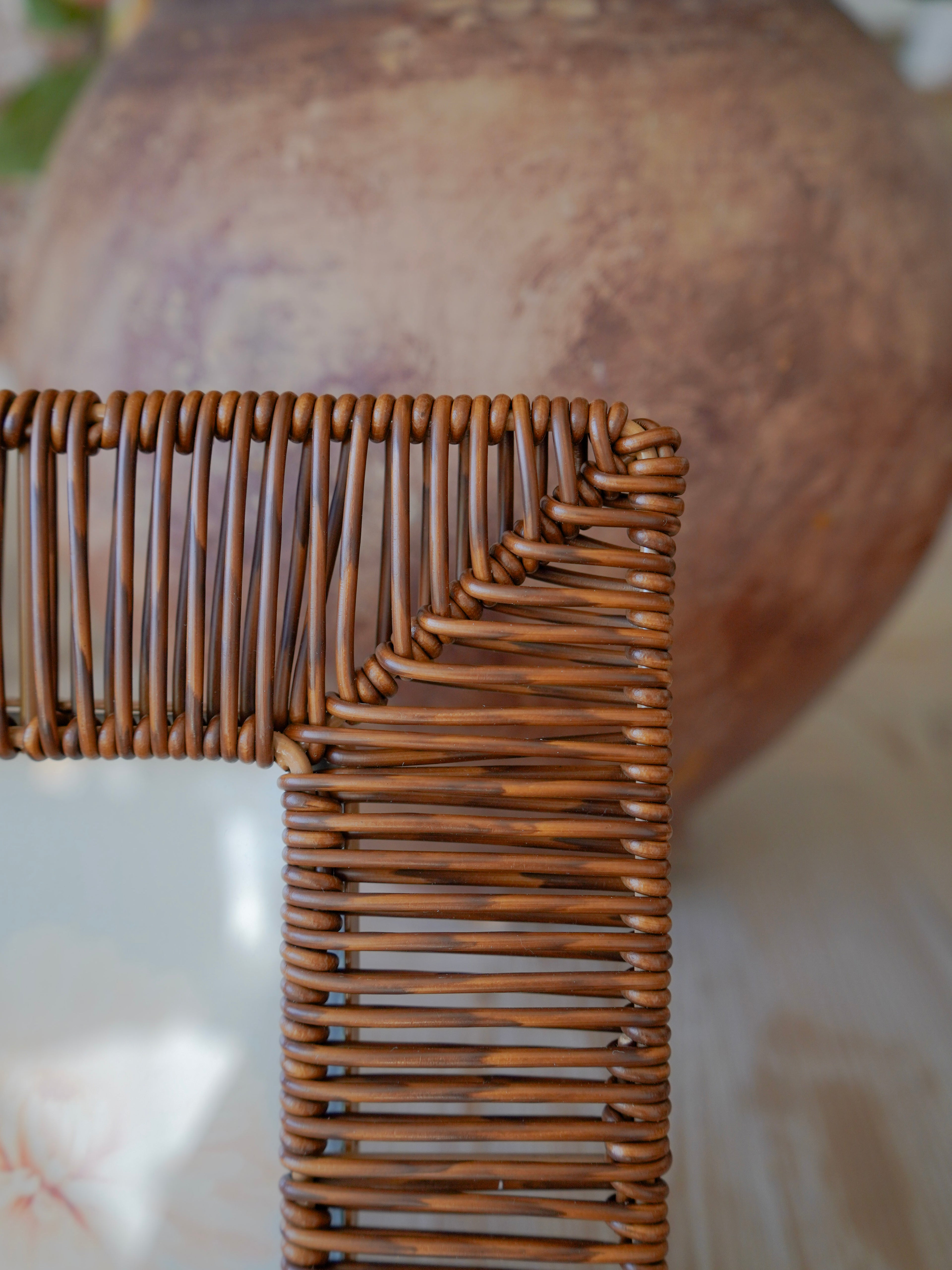 Close-up of a wicker photo frame corner with a blurred background