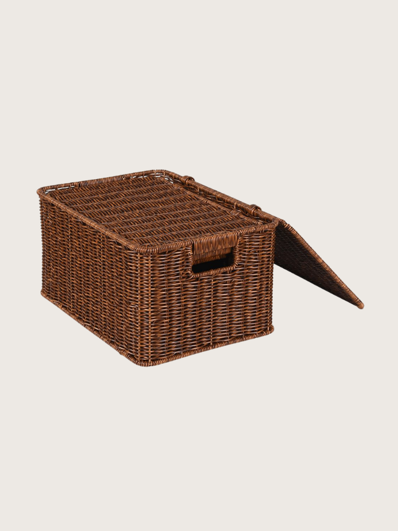 Brown wicker basket with a lid on a beige background