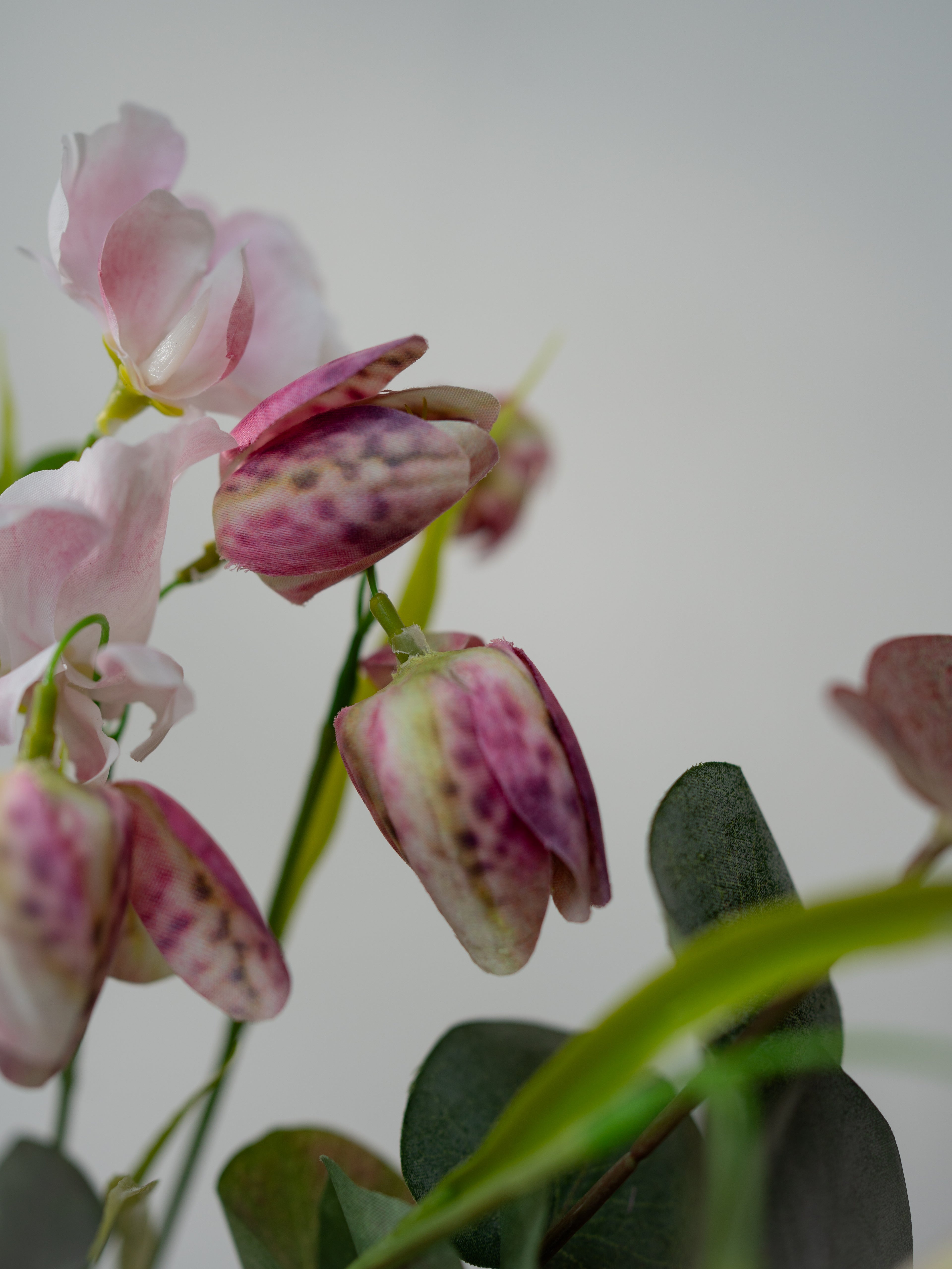 Pink and green faux flowers with a blurred background