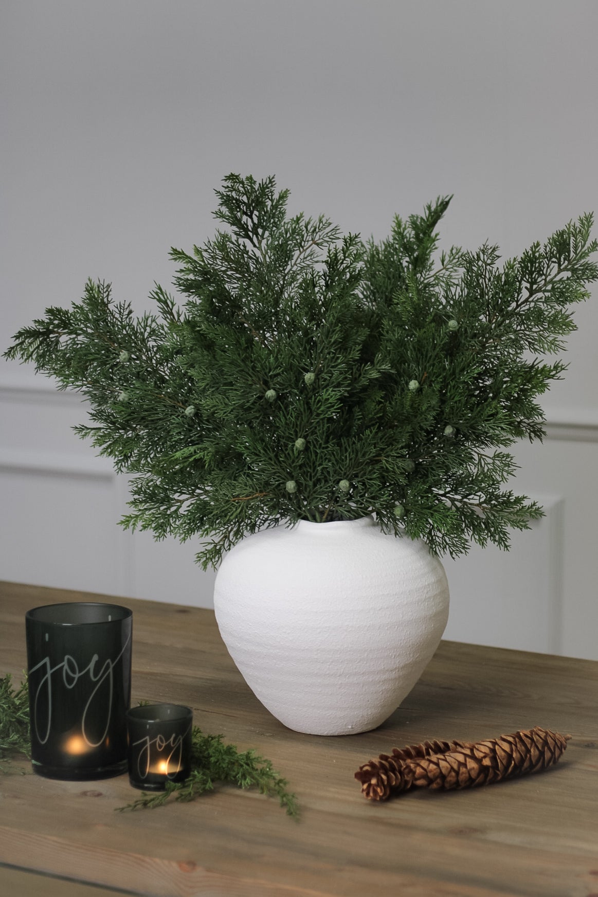 Faux Woodland Cedar Spray in white ceramic vase