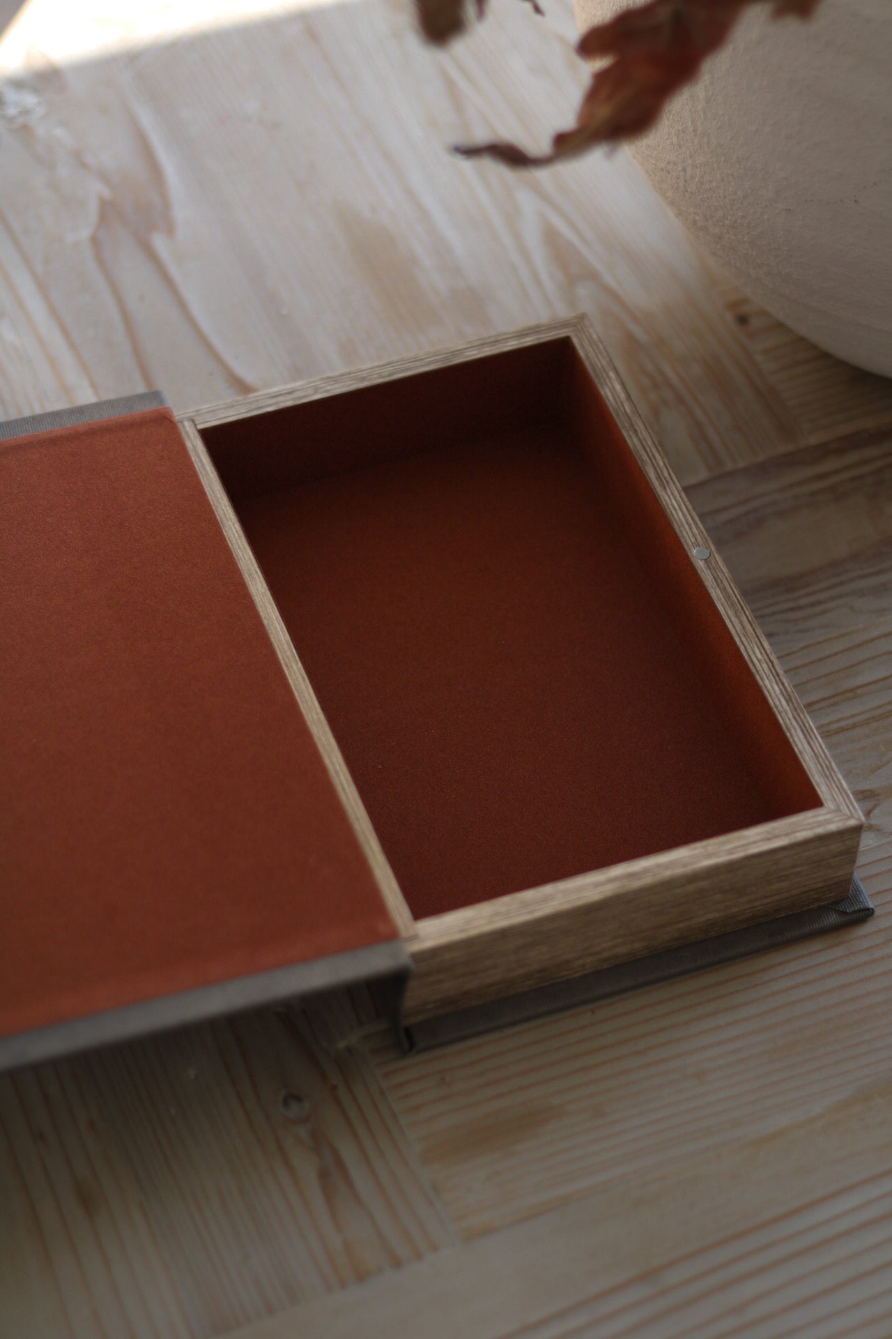 Wooden box with a red interior on a wooden surface