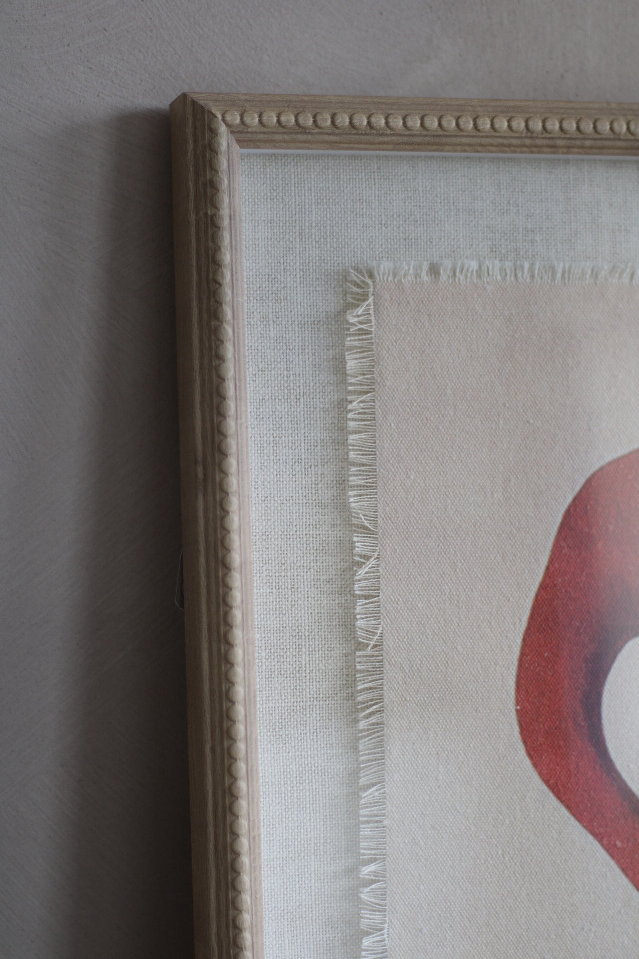 Framed artwork with a textured border on a grey wall