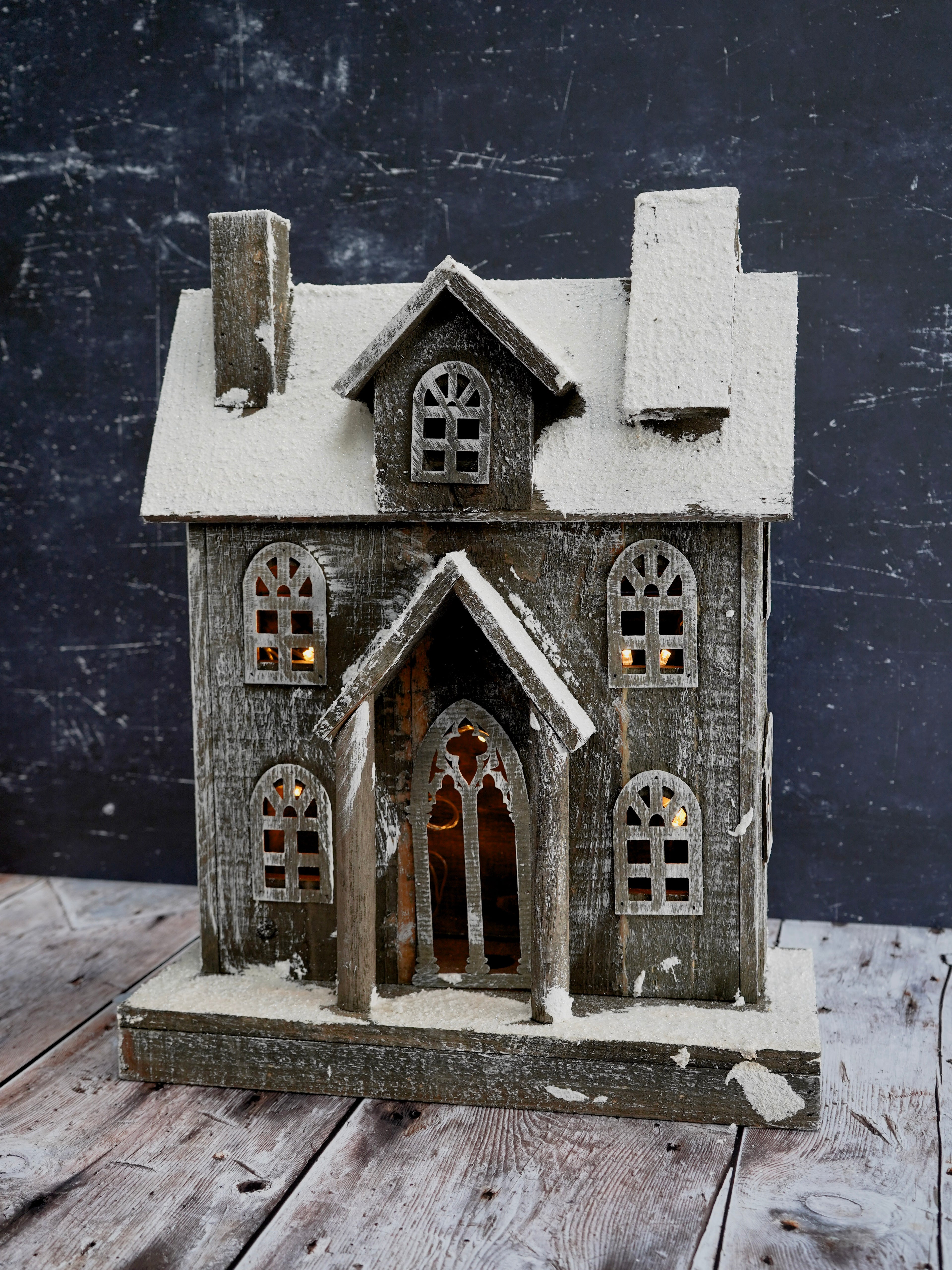 Decorative model of a house with a dark background