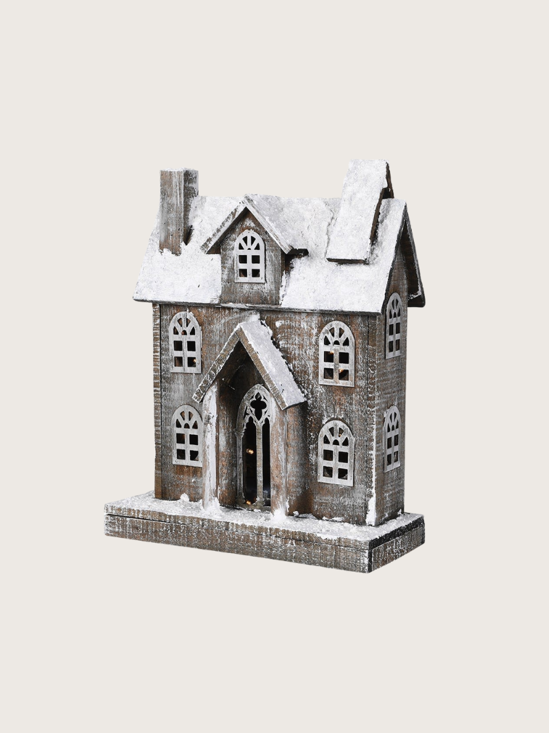 Decorative house model with snow on a white background