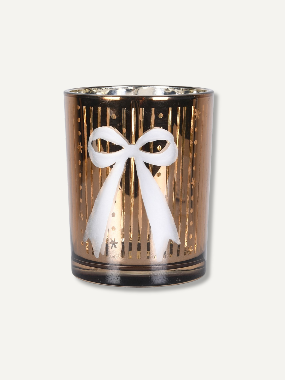 A gold-toned glass candle holder with a white bow design on the front, set against a plain off-white background.