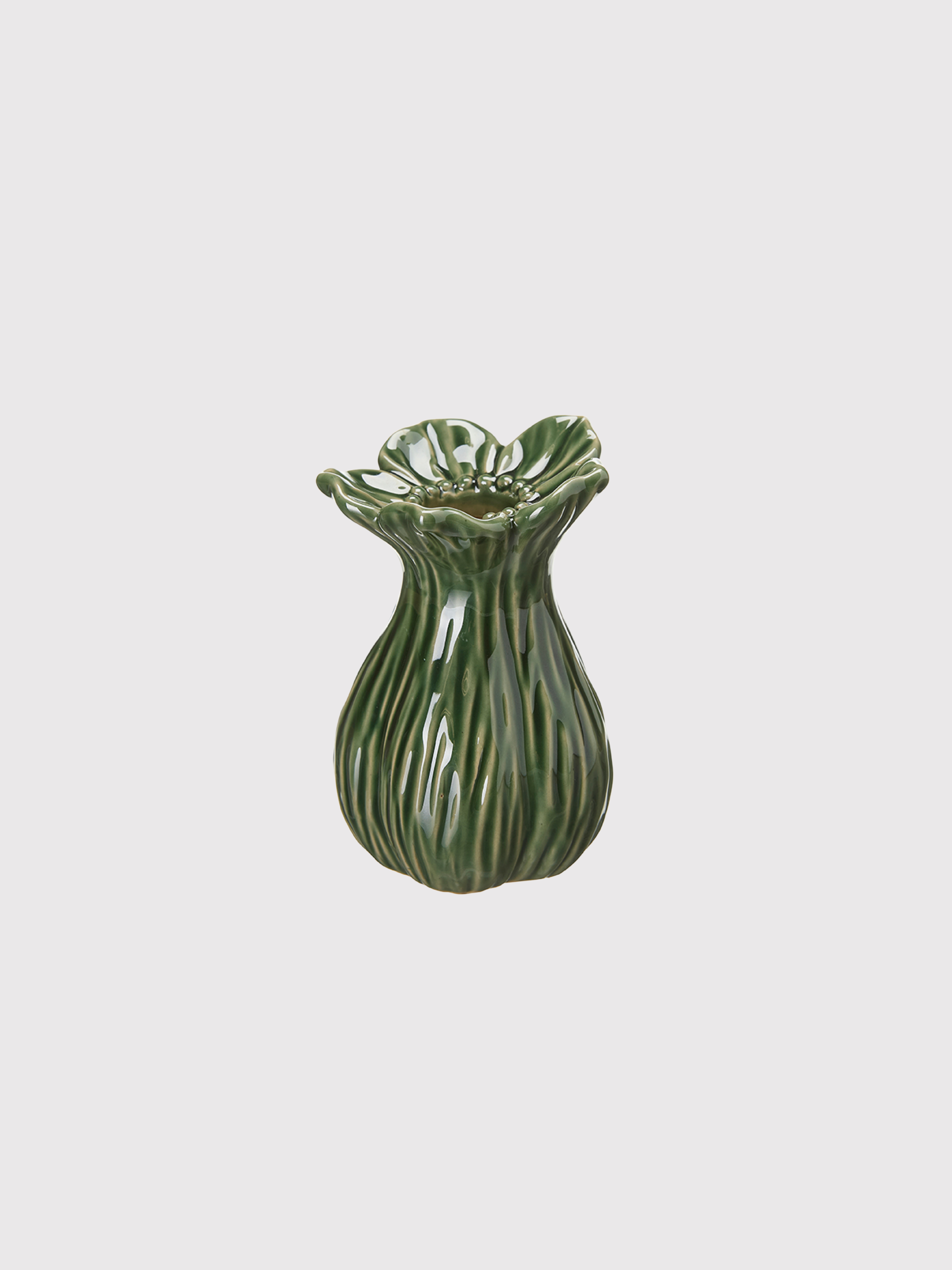 Green ceramic bud vase with textured surface on a light gray background