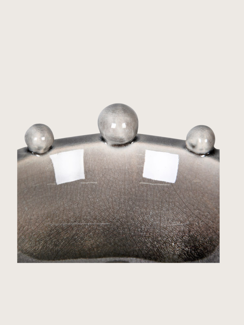 Decorative bowl with bobble elements on a white background