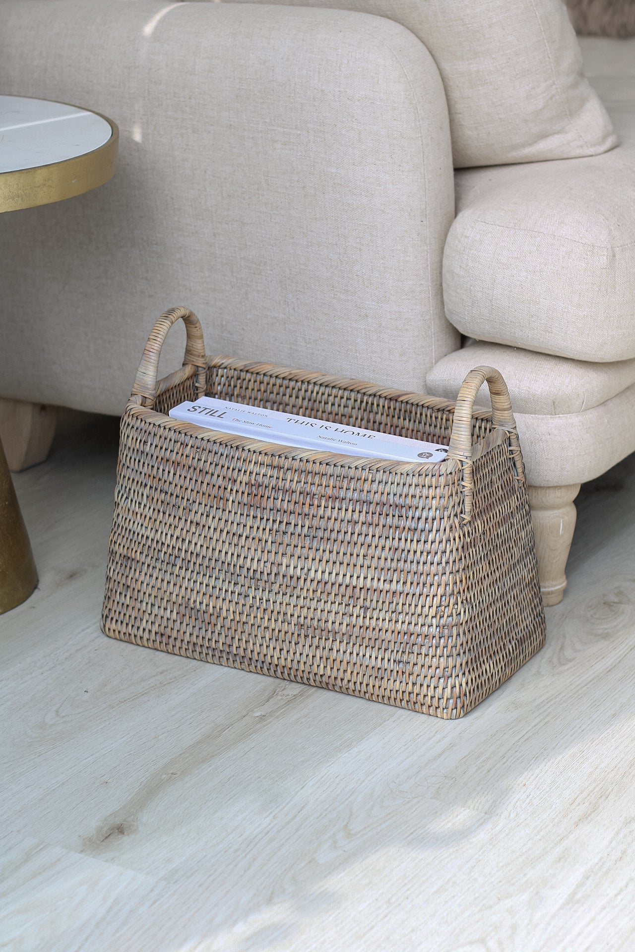Rattan basket by sofa