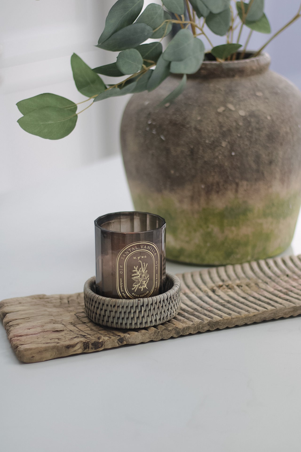 candle on wash board in rattan coaster