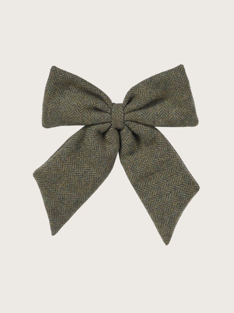 Green herringbone bow on a light gray background