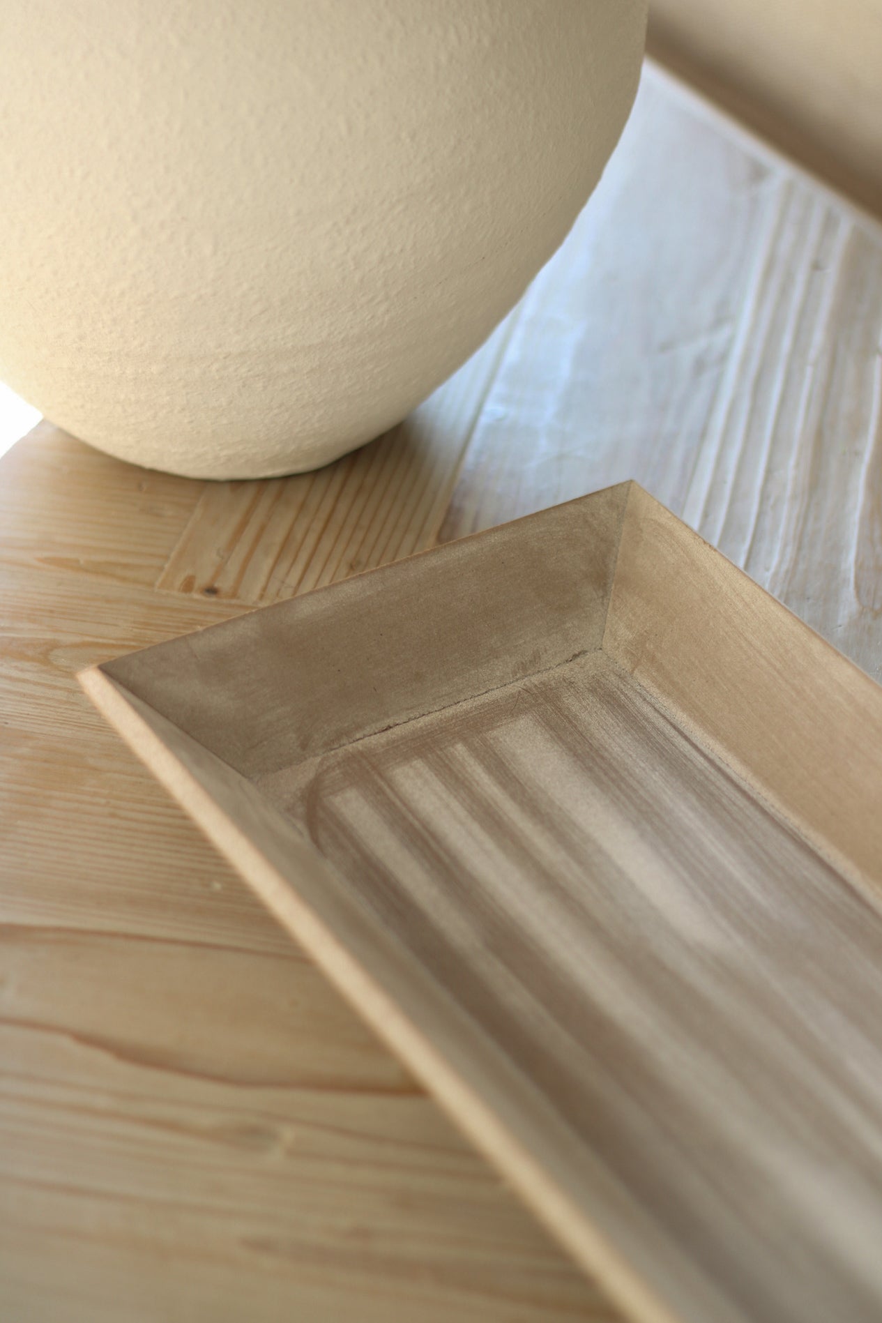 Wooden tray on a wooden surface with a blurred background