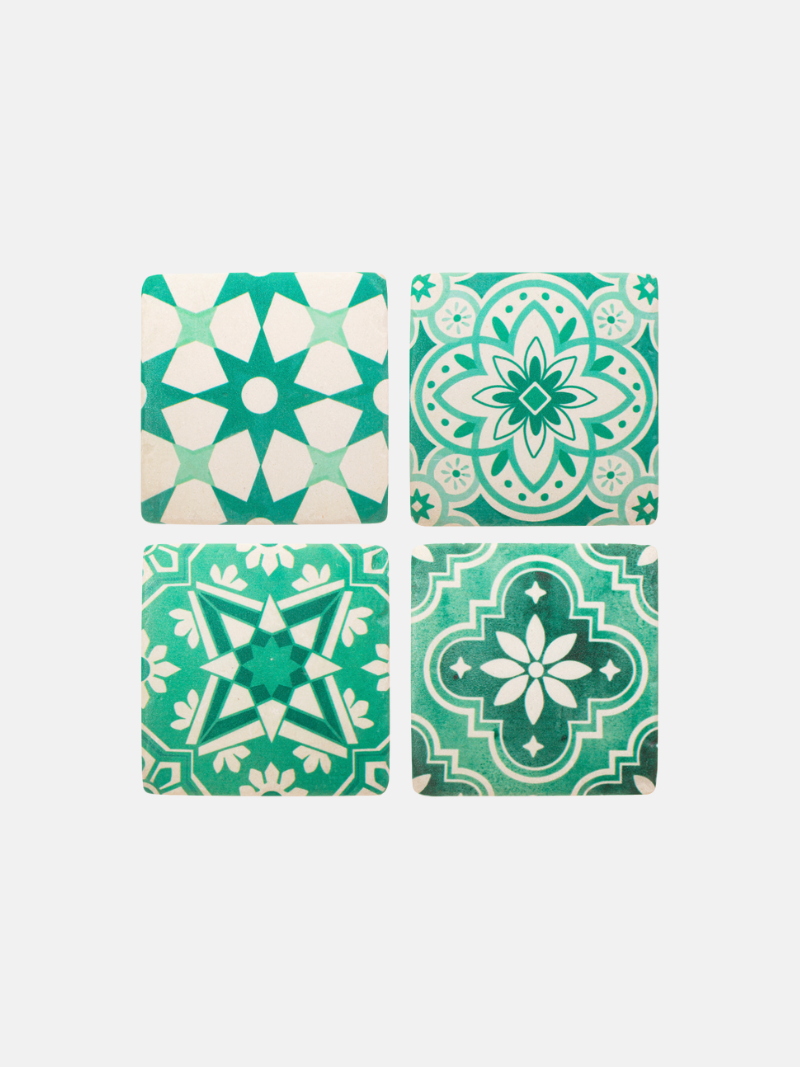 Four green and white patterned tiles on a white background