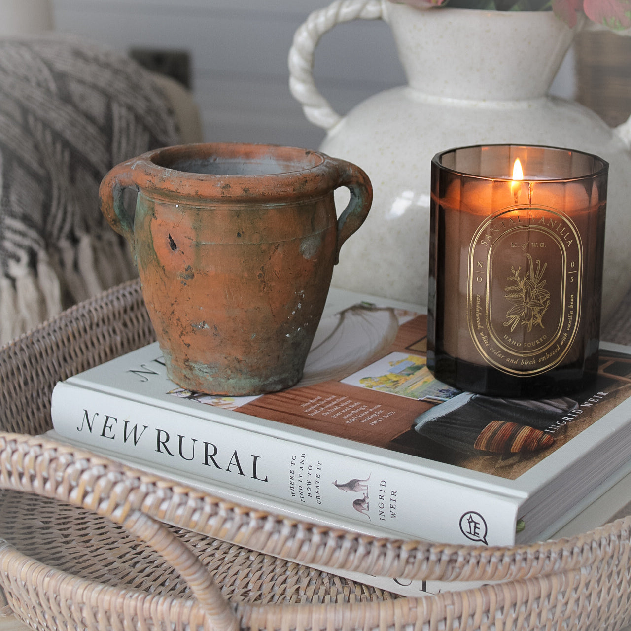 mini vintage olive pot on coffee table with rattan tray tray and lit candle