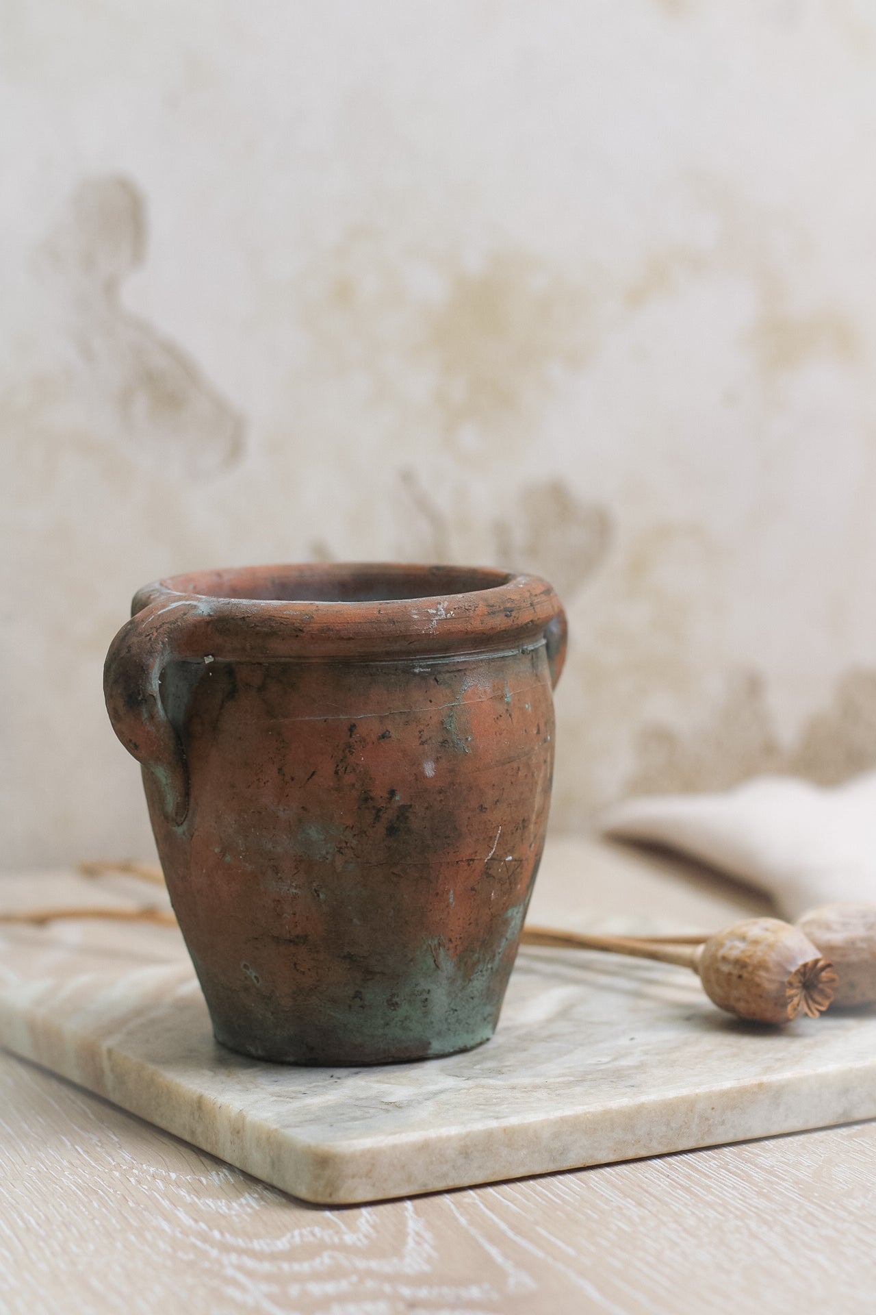 up close of small vintage olive pot