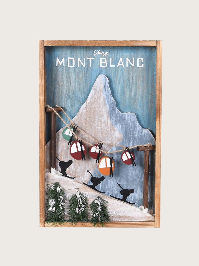 Framed artwork with mountain and skiers design, featuring the text &