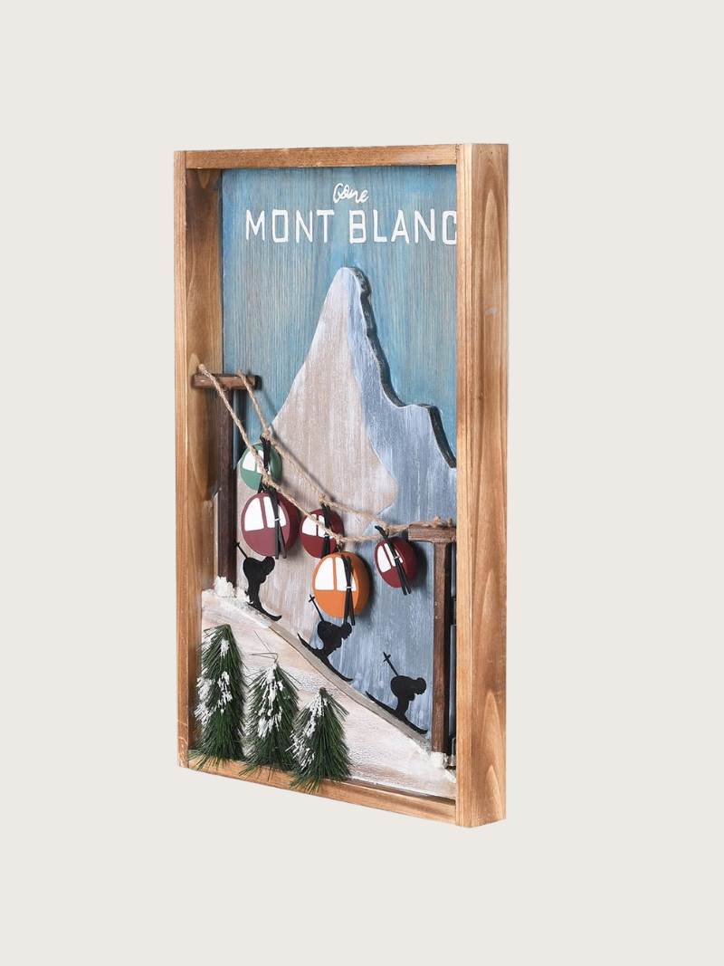 Wooden-framed artwork of Mont Blanc with skiers and a mountain peak.
