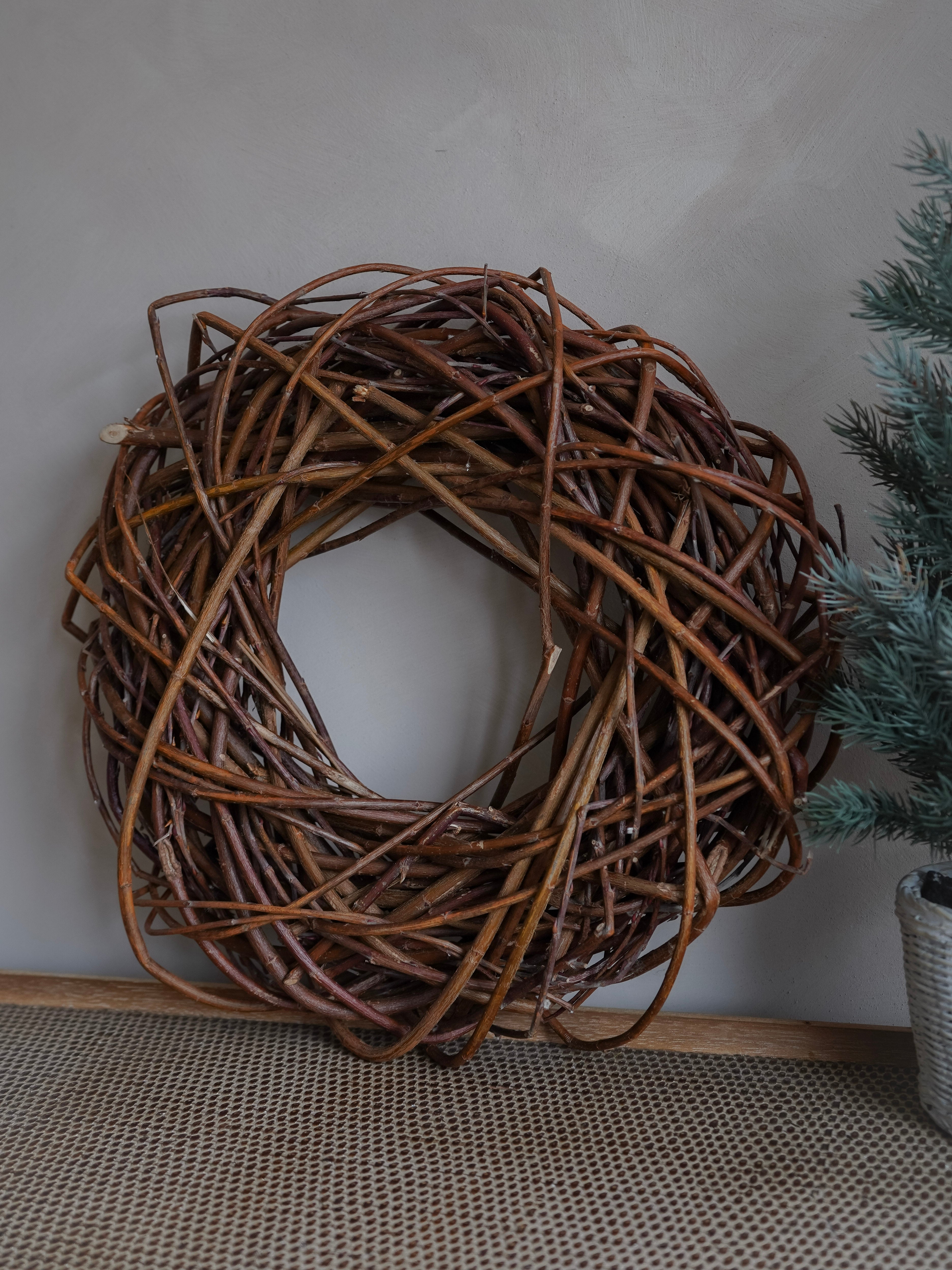 Woven branch wreath on a neutral background