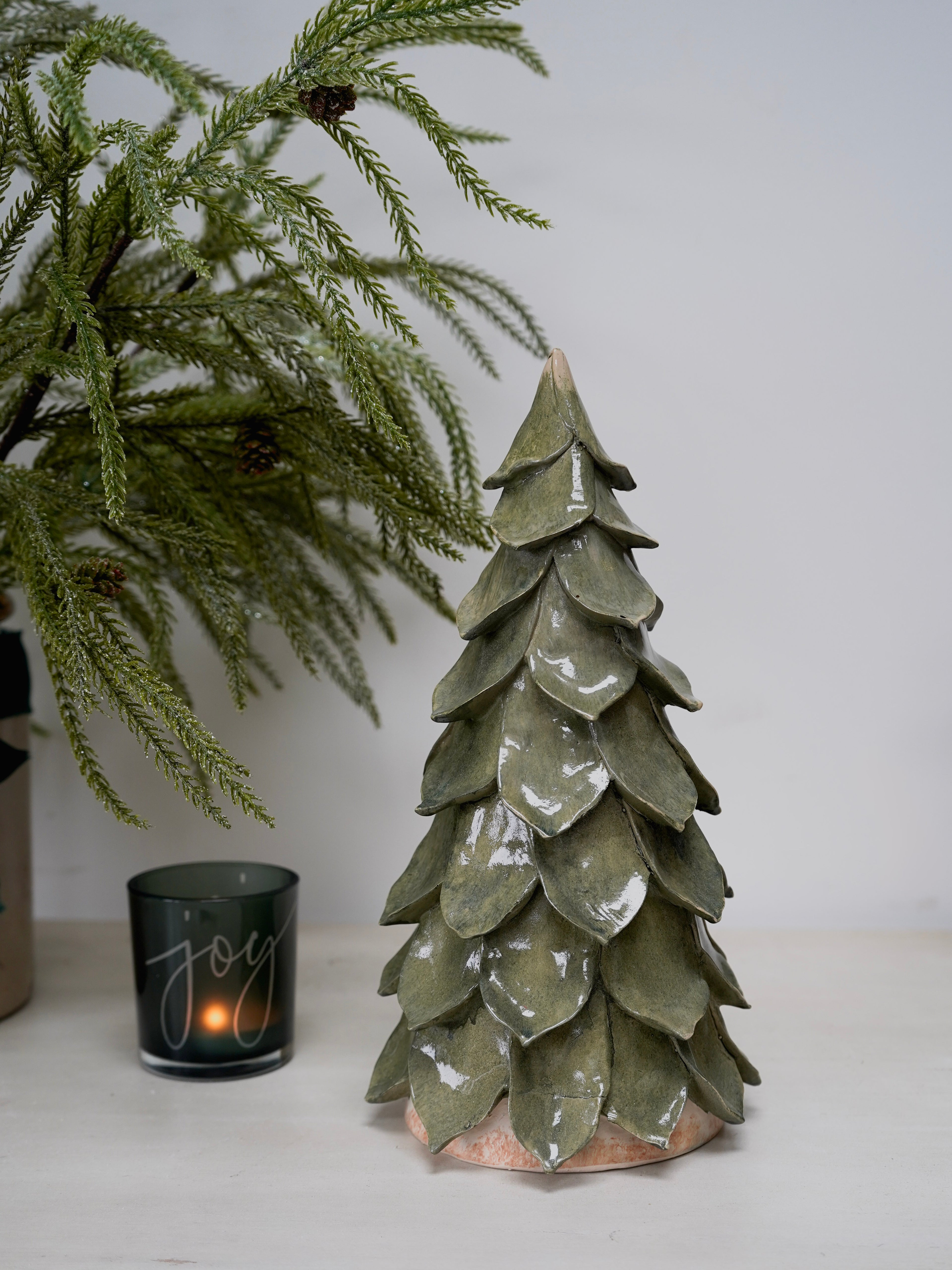 Decorative ceramic Christmas tree with a candle labeled &