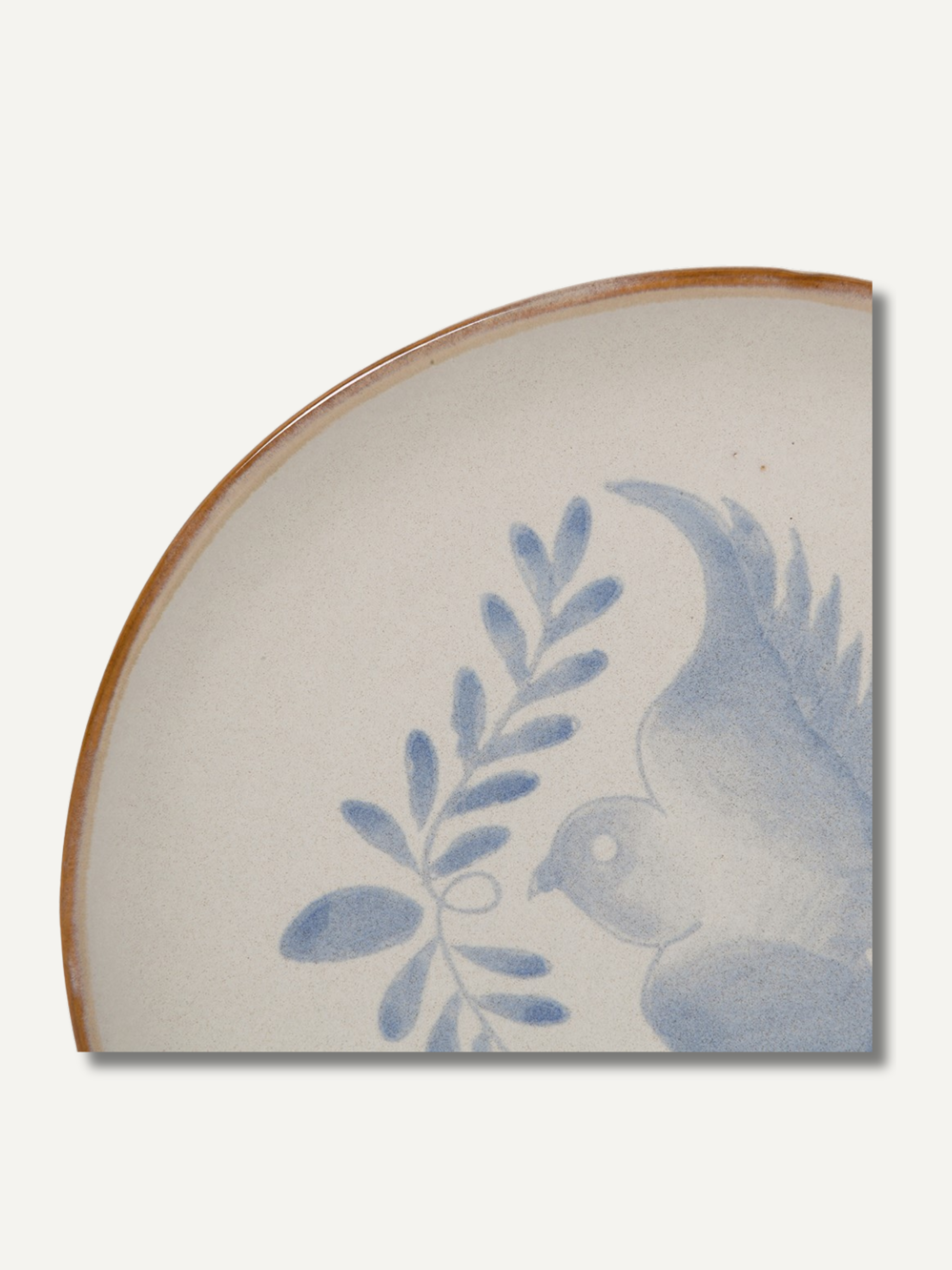 Up close of decorative ceramic plate with blue floral design on a white background