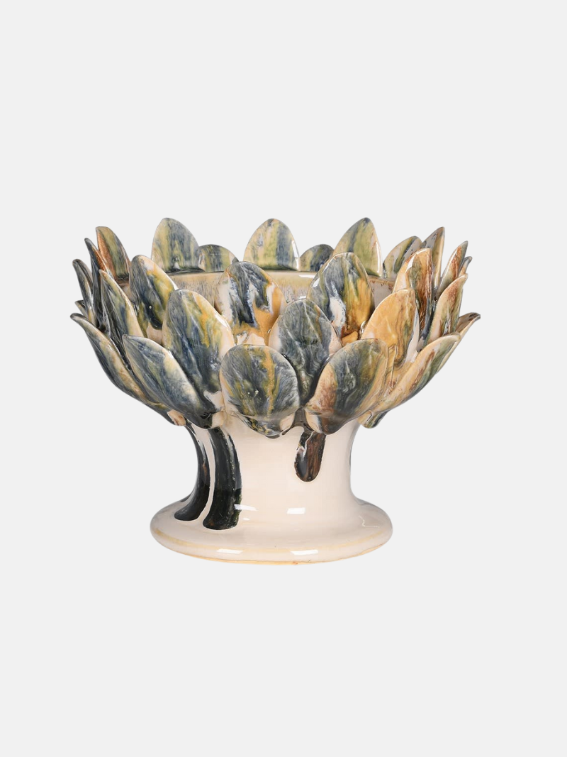 Decorative ceramic bowl with petal-like design on a white background