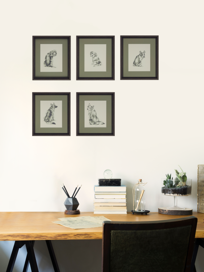 Framed puppy dog eyes artwork on a wall above a wooden desk with decor items.