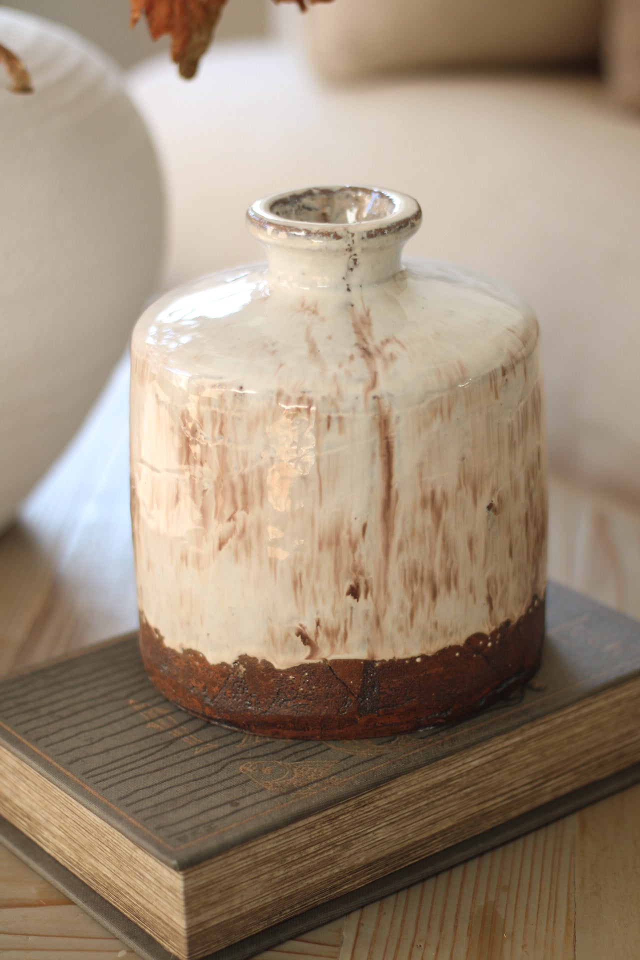 Terracotta vase with a rustic finish on a wooden surface