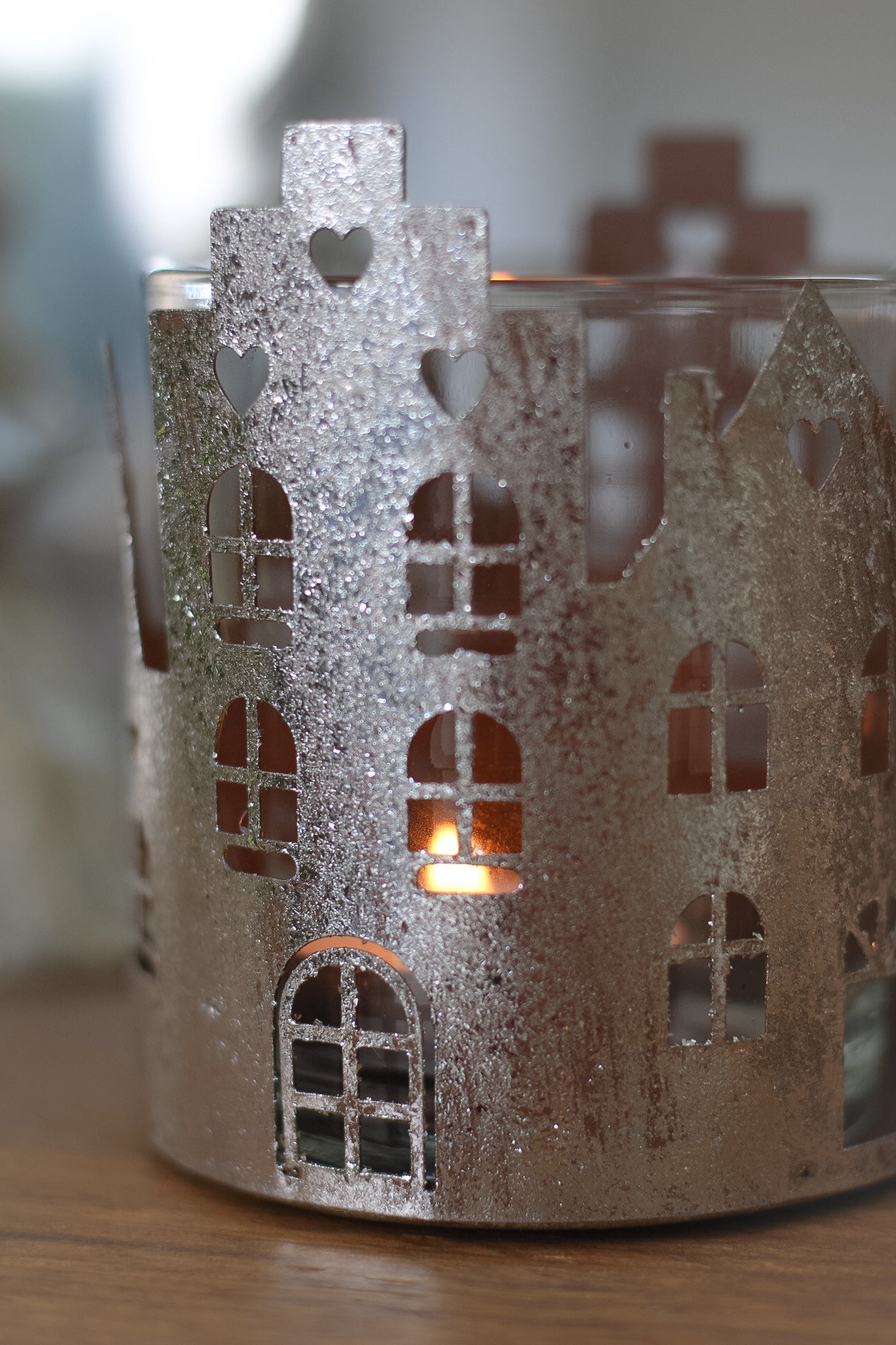 up close of metal town house candle holder for christmas decor