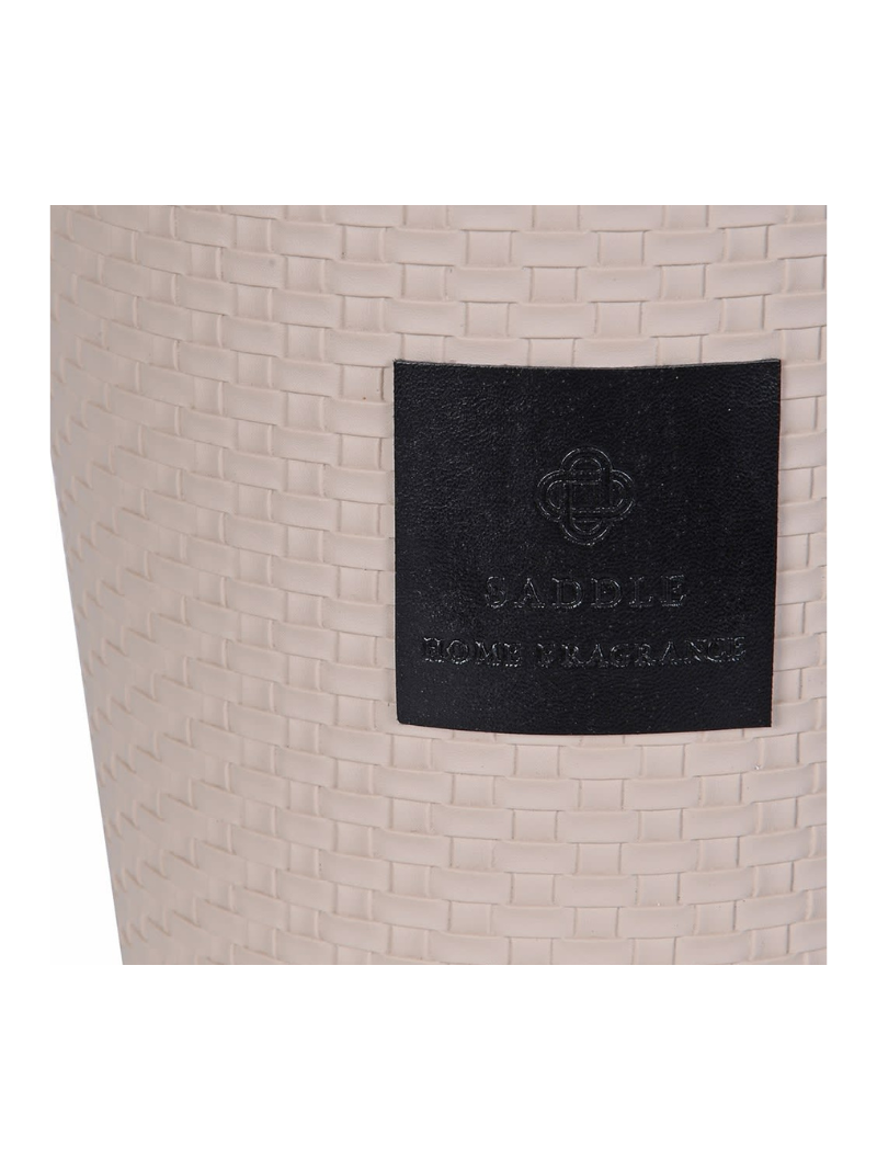 Beige woven bag with a black patch featuring a logo and text on a white background