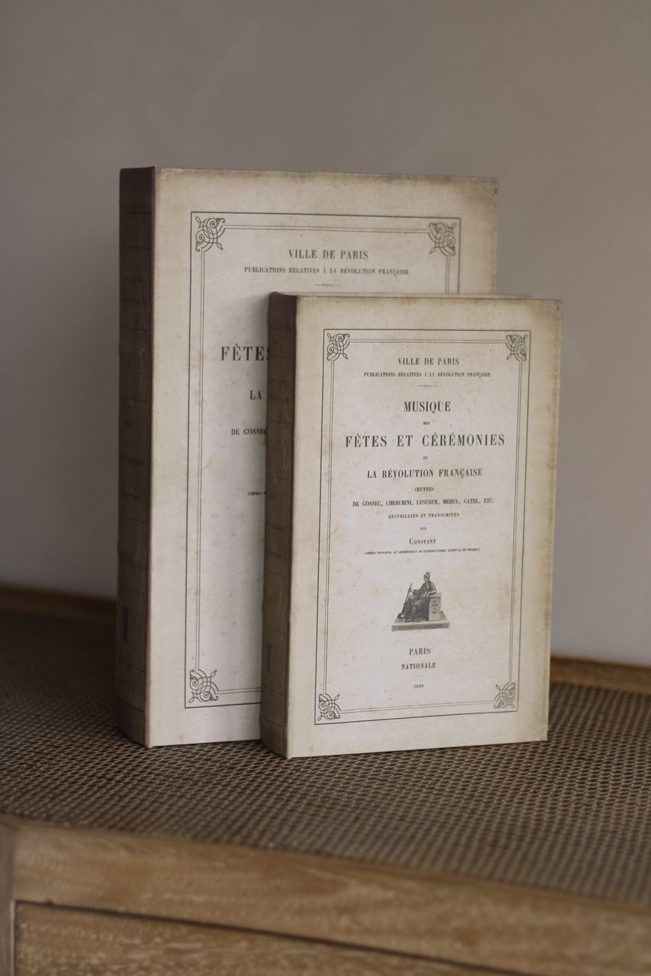 Two vintage books on a textured surface with a neutral background